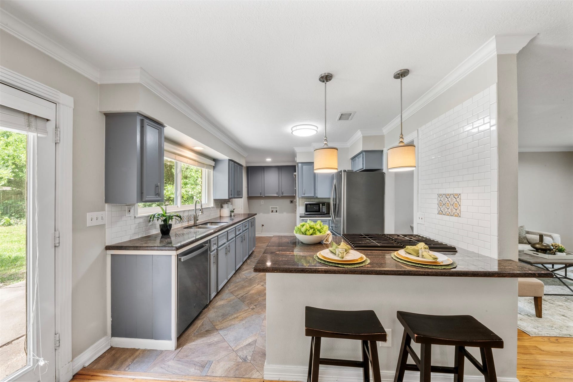 Sold cabinetry, granite counter tops and stainless appliances compliment this open kitchen.