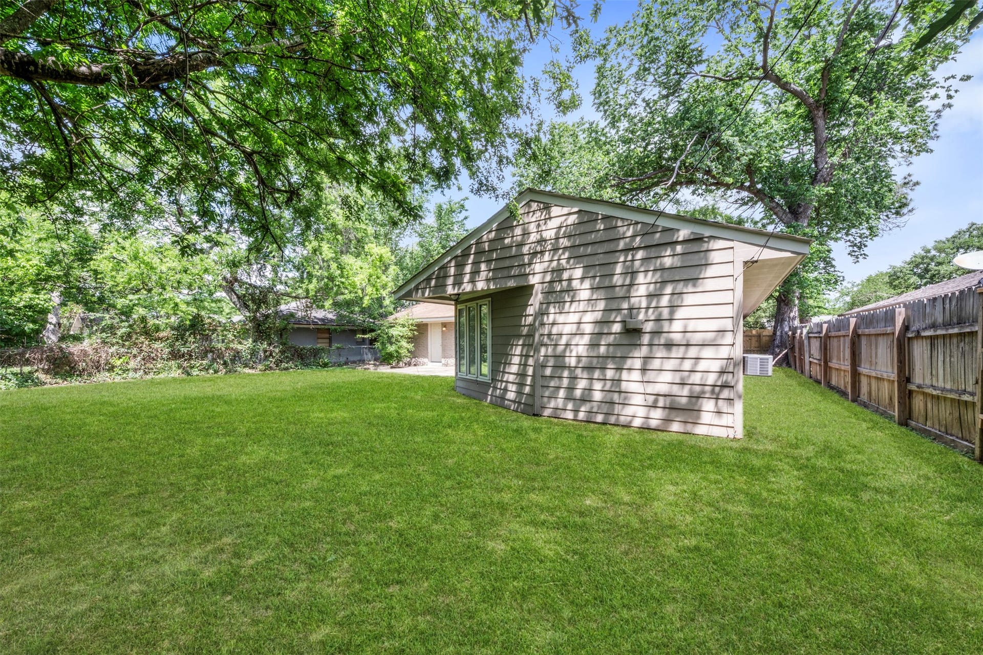 This backyard with mature landscaping is perfect for entertaining family and friends.