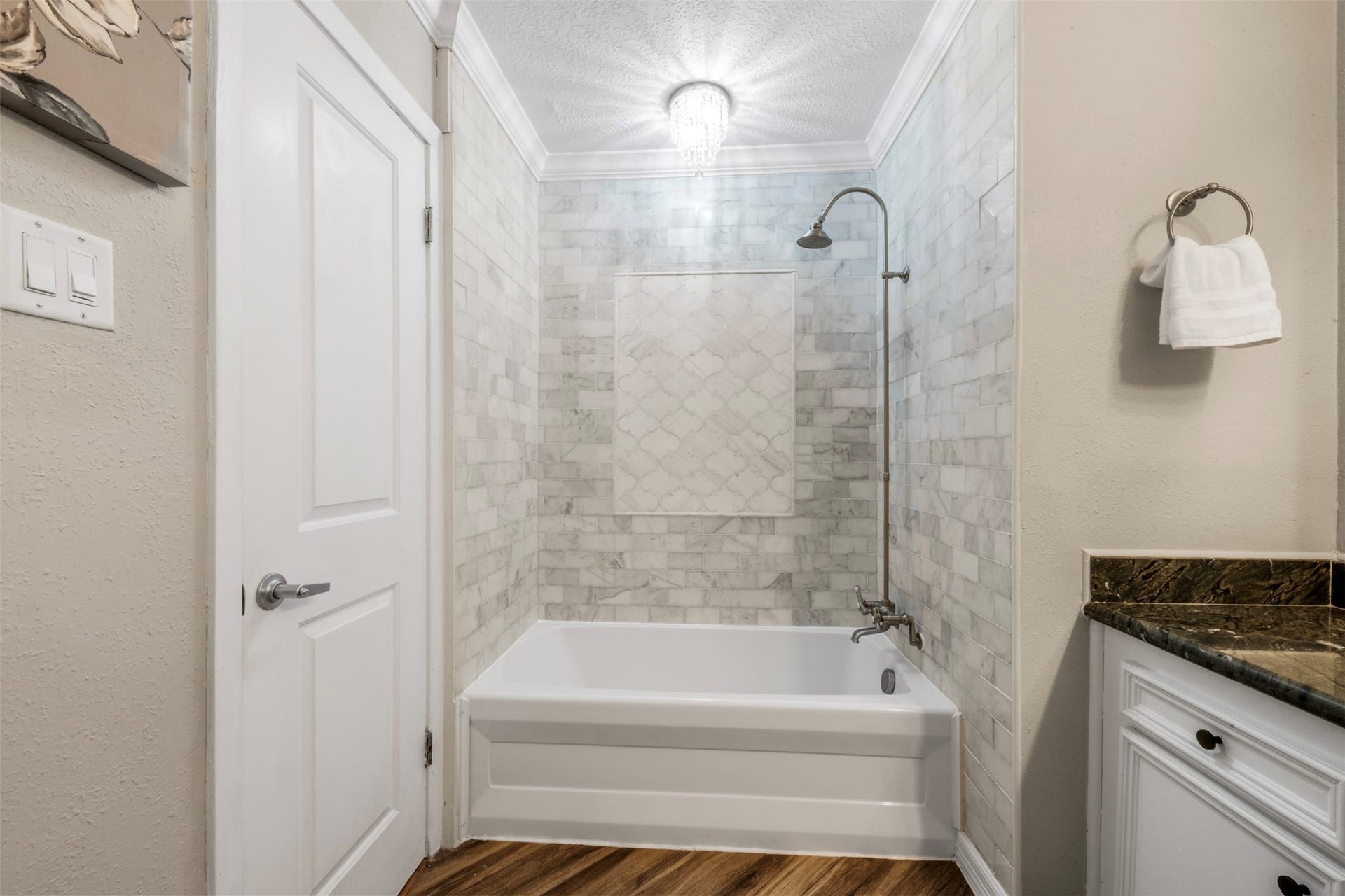 The hall bathroom features a beautifully updated shower and bathtub.