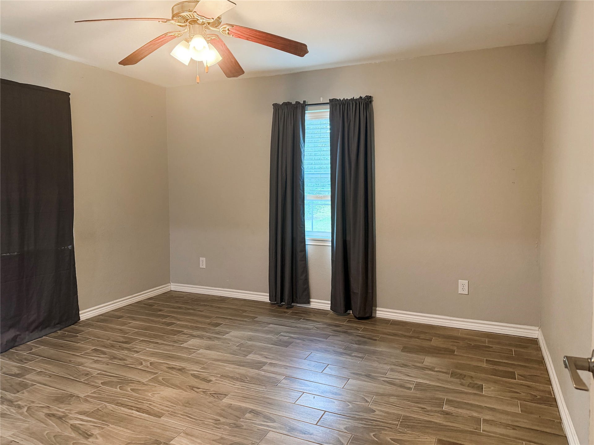 816 W Mulberry, Angleton, TX 77515 Primary bedroom conveniently located on the first floor, offering easy access and a comfortable space to relax and unwind.
