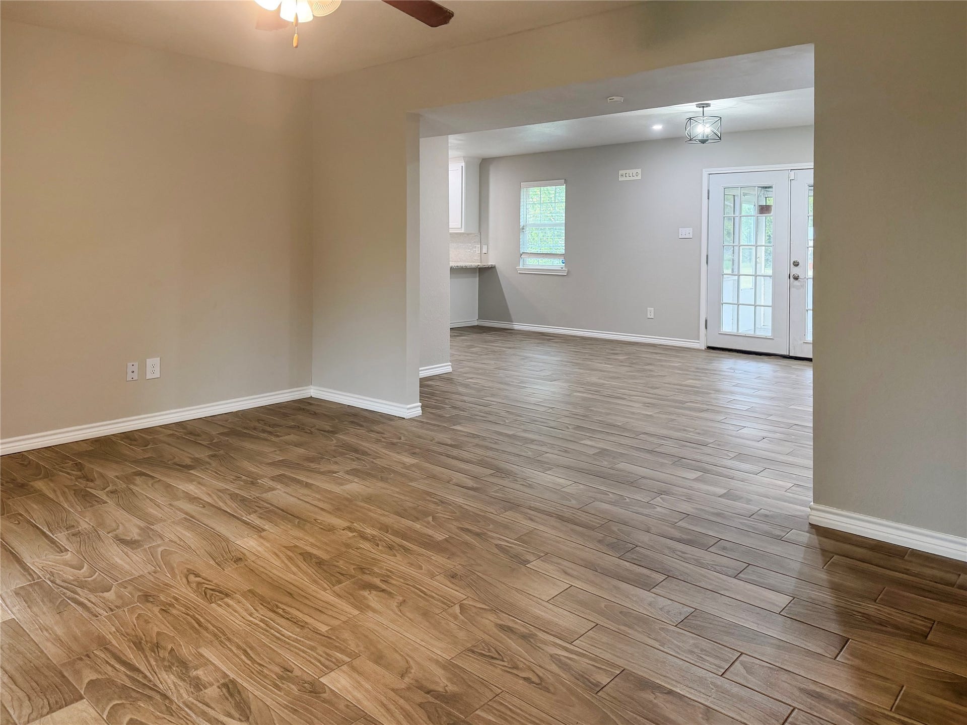 816 W Mulberry, Angleton, TX 77515 Living room flows seamlessly into the open dining area, creating an inviting layout with easy access between living and dining spaces.