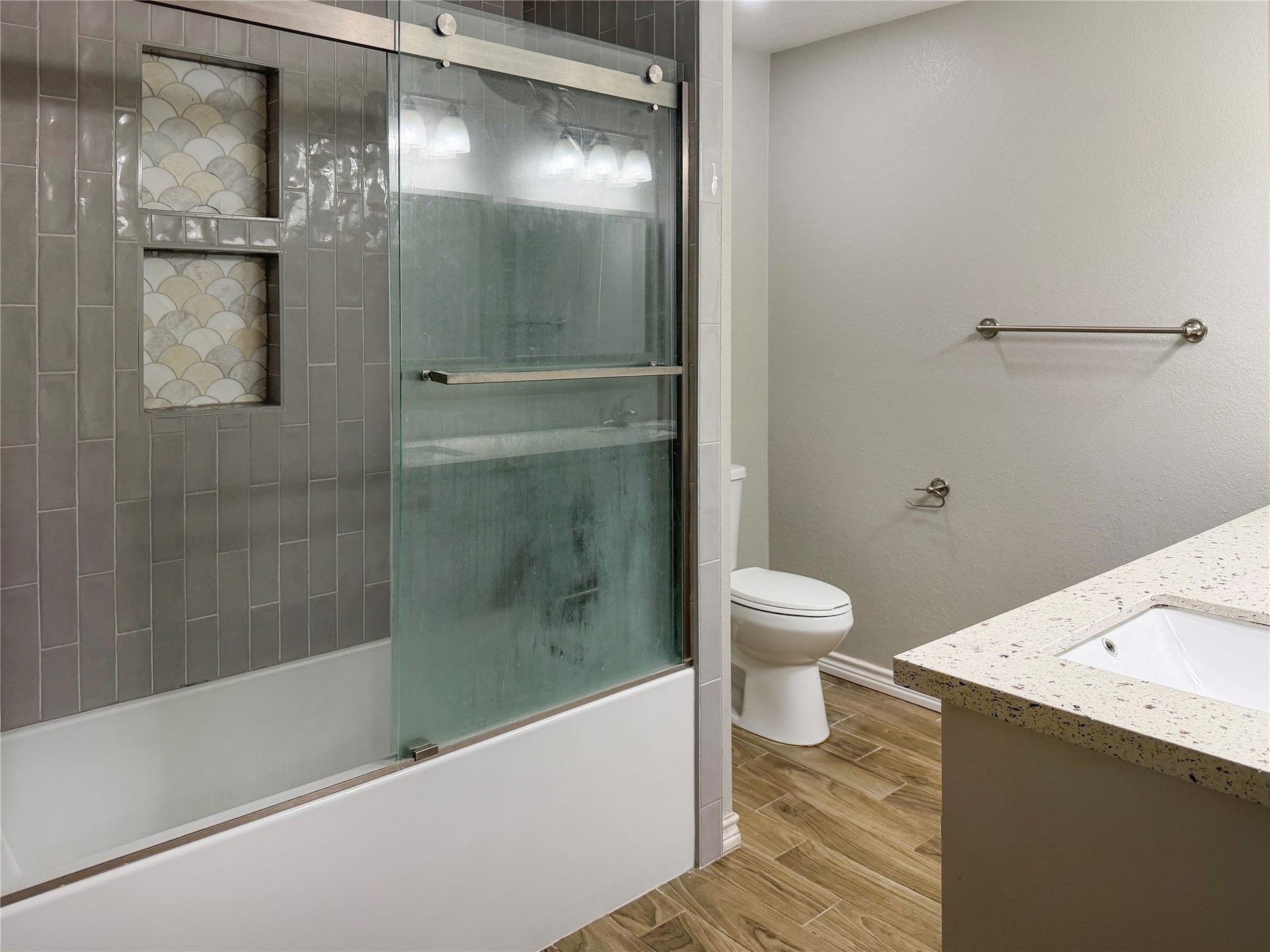 816 W Mulberry, Angleton, TX 77515 Primary bathroom features a tub and shower combination with a glass door, offering a clean, functional space for everyday use.