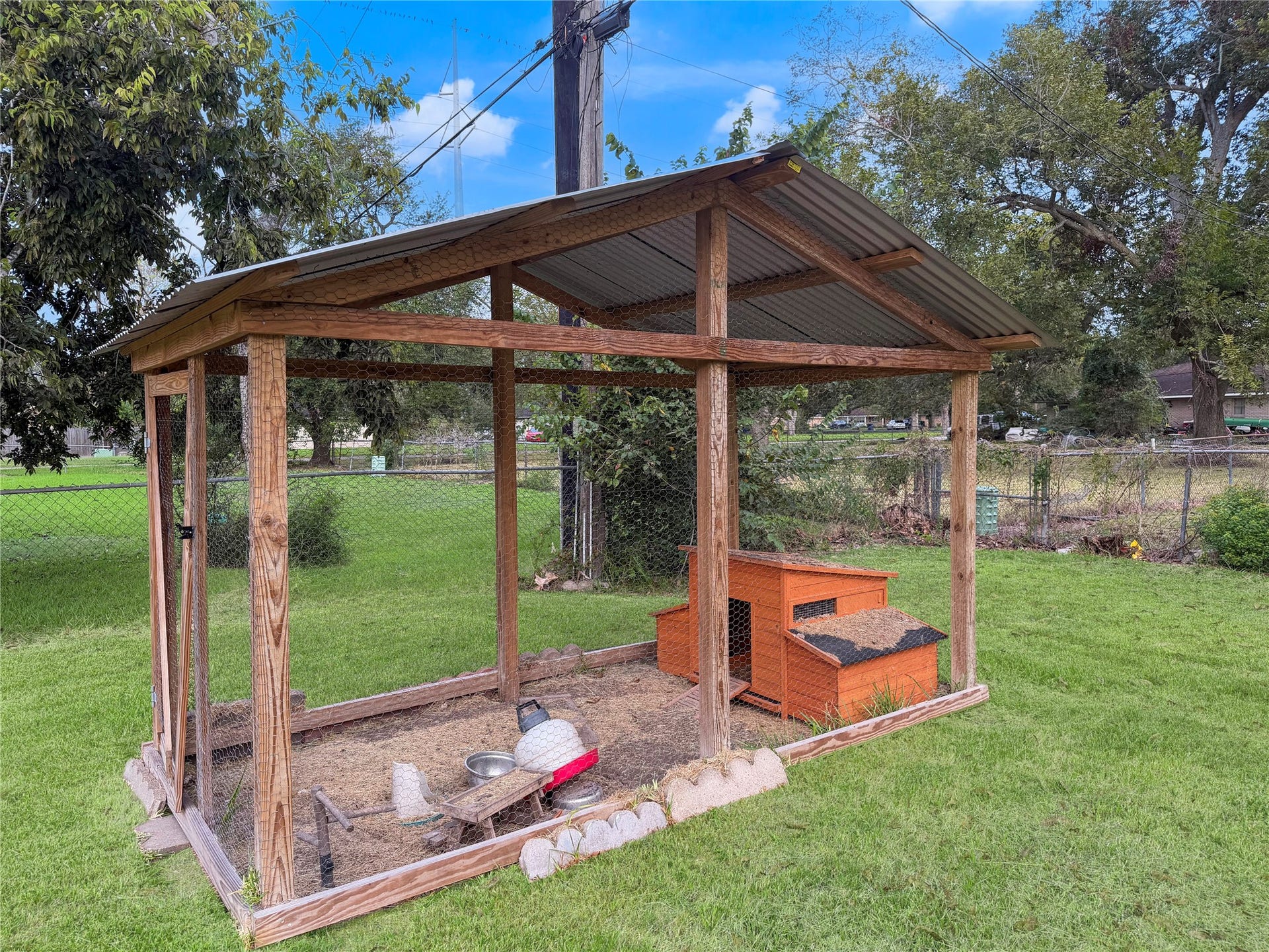 816 W Mulberry, Angleton, TX 77515 Small chicken coop located in the backyard, offering a designated space for keeping chickens or other small-scale backyard farming activities.
