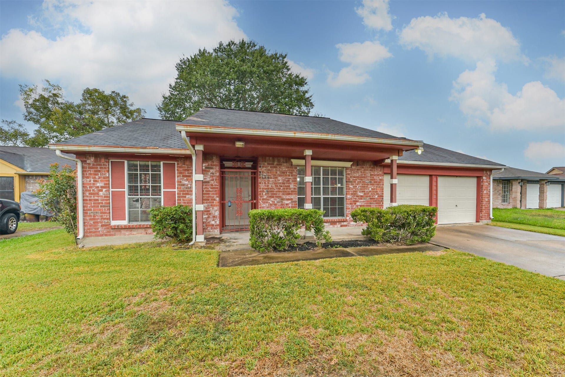 16510 Quiet Quail Drive, Houston, TX 77489 Charming brick home with a welcoming front porch, lush green lawn, and 2 car garage.