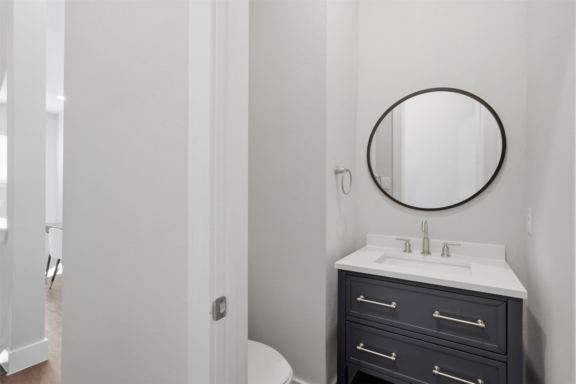 1444 W 34th 1/2 Street, Houston, TX 77018 Conveniently located off the main living area, the powder bath features a custom vanity, quartz countertop, and clean contemporary finishes.