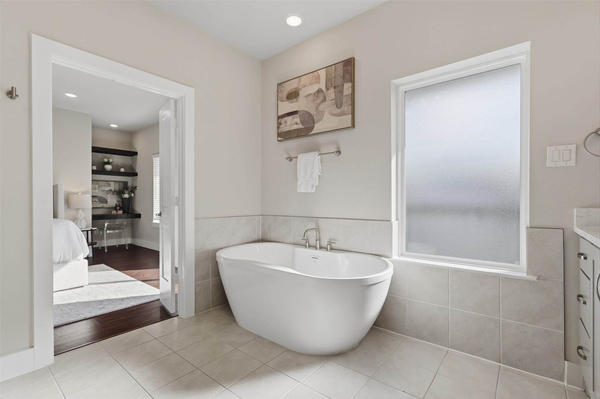 1444 W 34th 1/2 Street, Houston, TX 77018 The freestanding soaking tub creates a relaxing focal point, complemented by a large frosted window that brings in natural light while maintaining privacy.