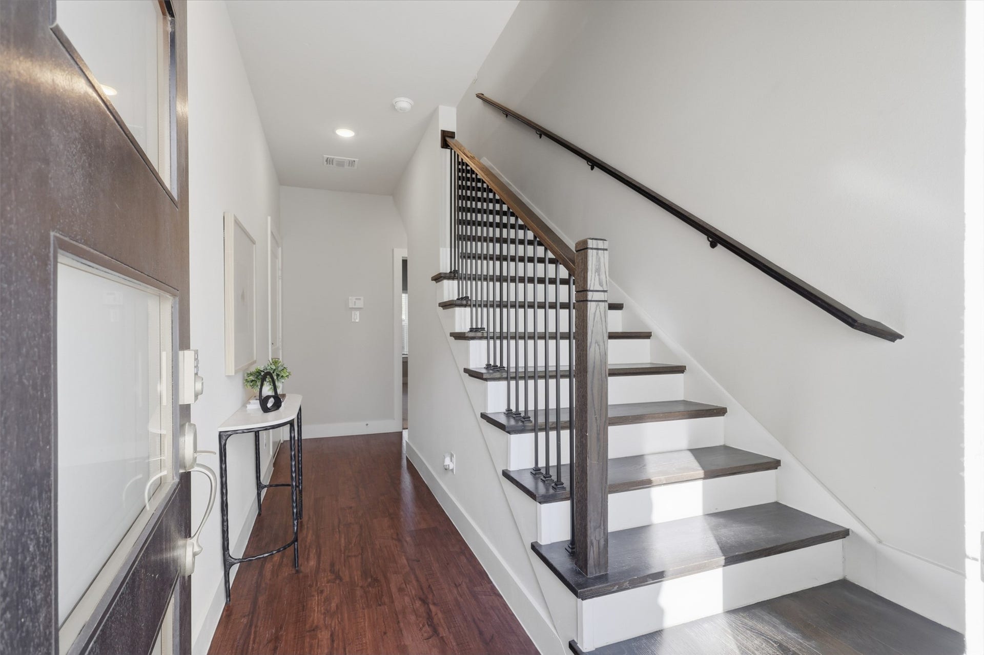 1444 W 34th 1/2 Street, Houston, TX 77018 A bright, modern entry welcomes you in with clean architectural lines, contemporary stair railings, and a sleek transitional design that sets the tone for the rest of the home.