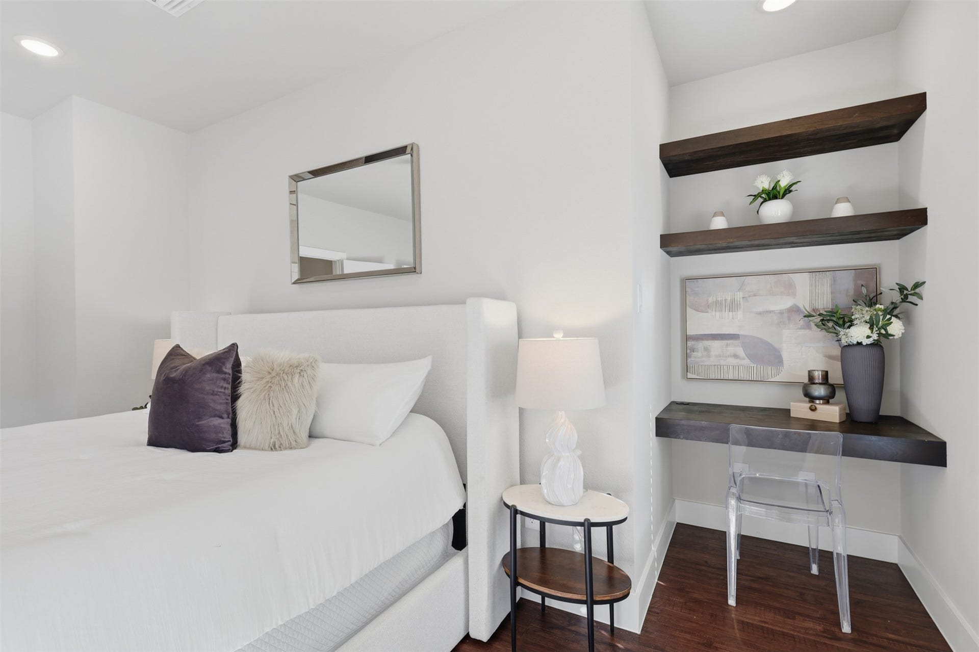 1444 W 34th 1/2 Street, Houston, TX 77018 Another view of the primary suite highlights a built-in desk and floating shelves, creating a stylish dedicated workspace without sacrificing bedroom space.