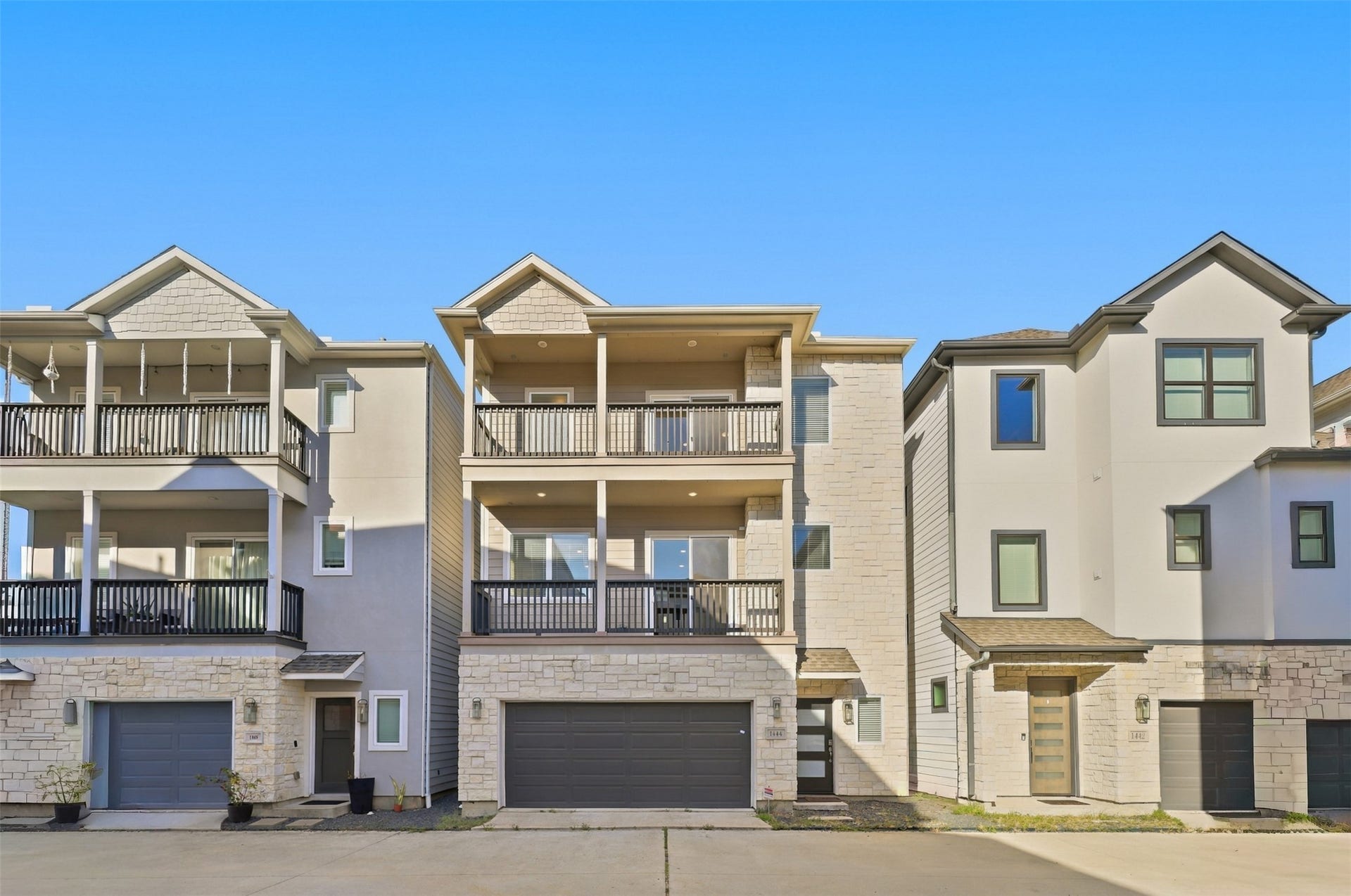 1444 W 34th 1/2 Street, Houston, TX 77018 Modern three-story design, stone accents, and dual covered balconies within the gated Parkview community.
