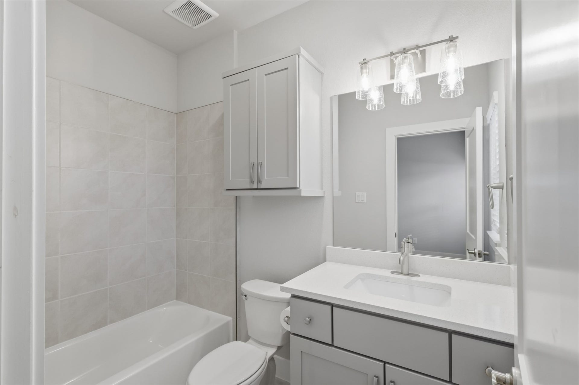 1444 W 34th 1/2 Street, Houston, TX 77018 Private full bath serving the first-floor secondary suite, finished with quartz countertops, modern cabinetry, and a clean, timeless design.