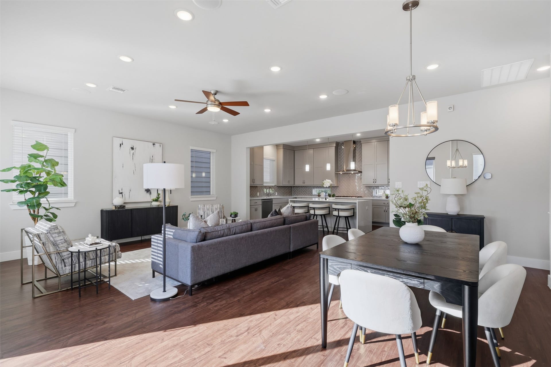 1444 W 34th 1/2 Street, Houston, TX 77018 The open-concept living and dining spaces flow seamlessly into the kitchen, creating one connected gathering space with plenty of room to host.