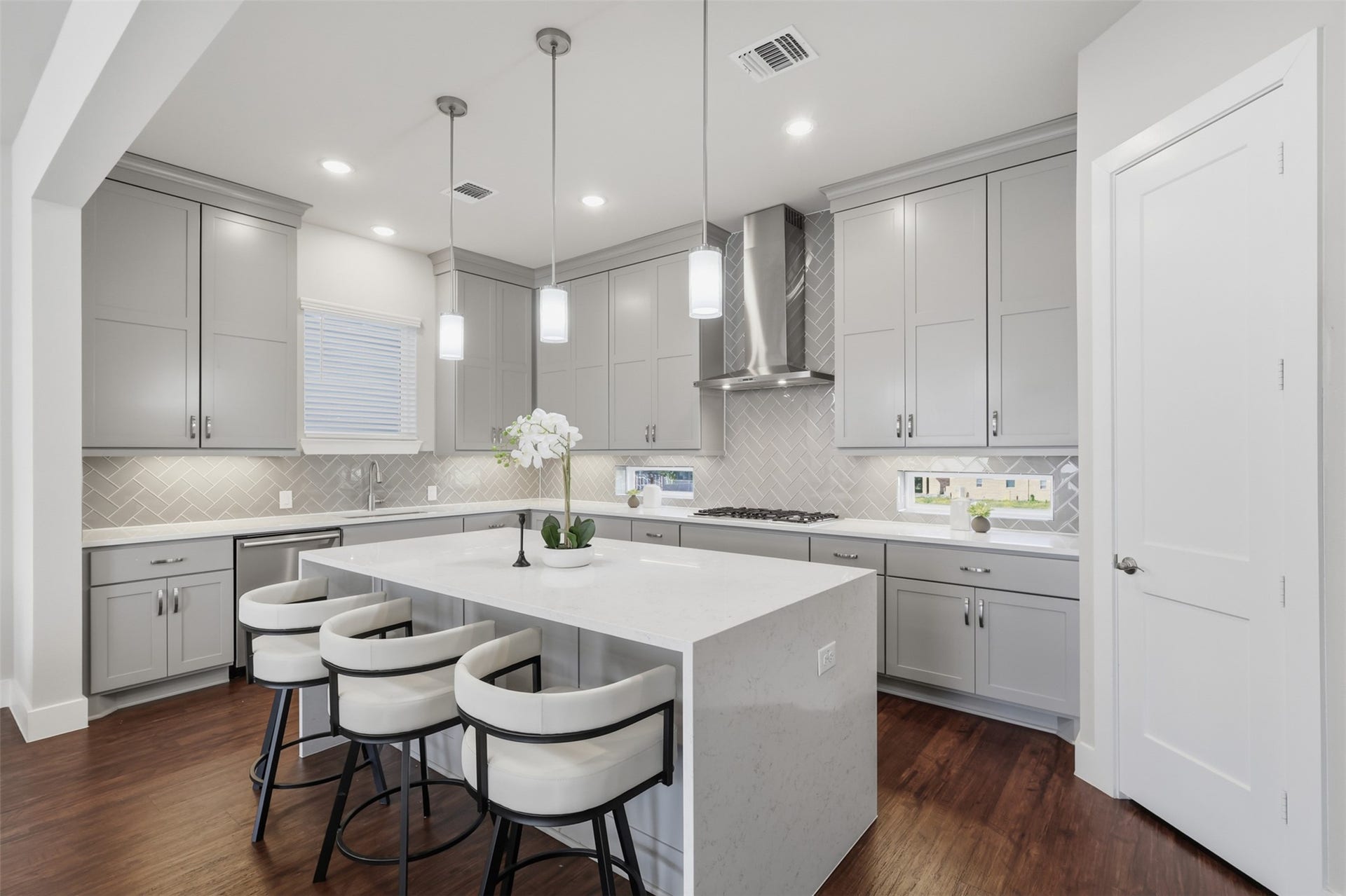 1444 W 34th 1/2 Street, Houston, TX 77018 Another angle highlights the generous cabinet storage, expansive counter space, gas cooktop, and oversized island with seatingan ideal setup for cooking, entertaining, and everyday living.