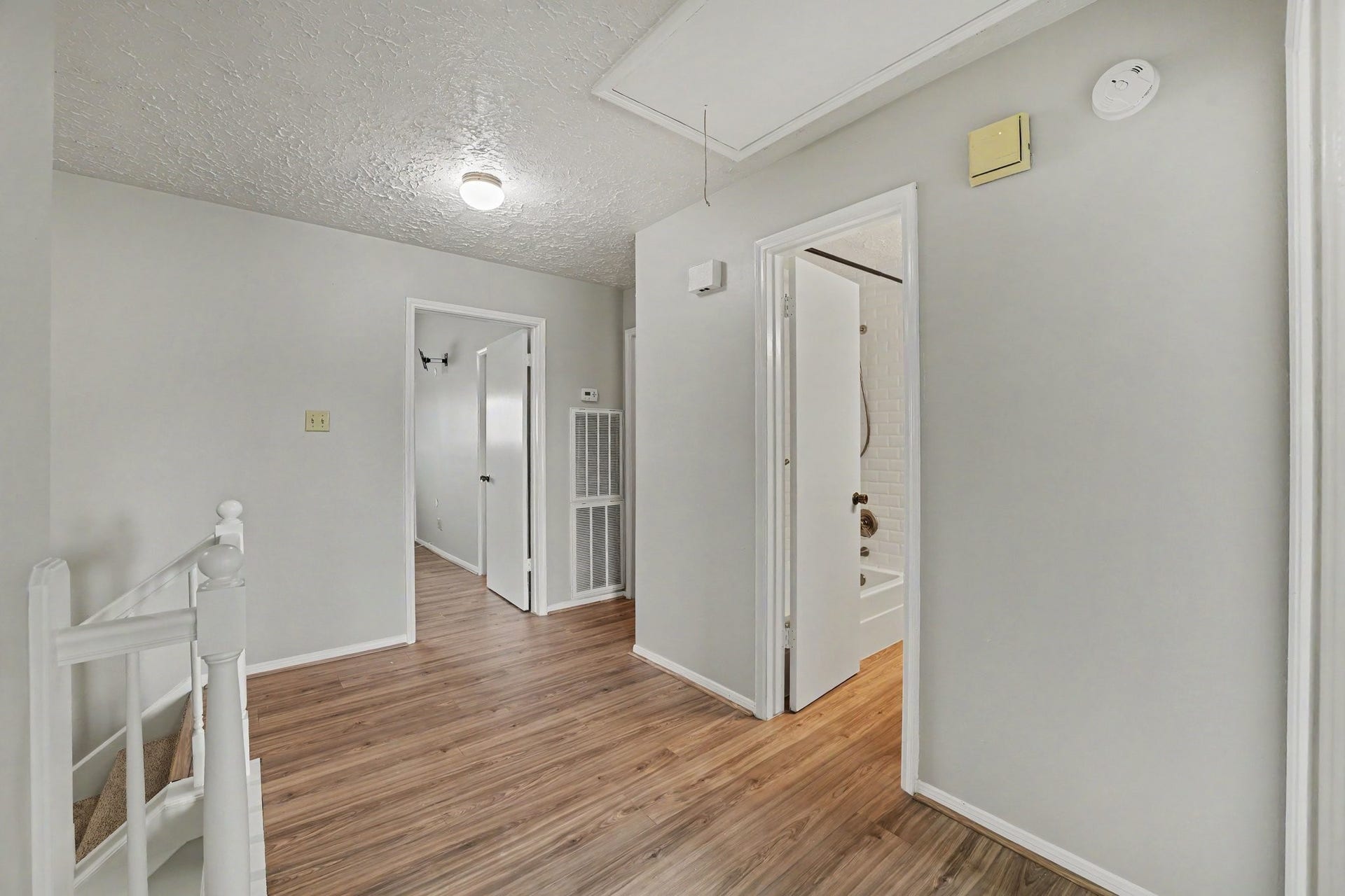 44 Chapparal Court, Missouri City, TX 77459 At the top of the stairs, a bright central landing warmly connects the home's second-floor living quarters. Rich, warm-toned wood-plank flooring flows across the landing, contrasting handsomely with soft grey walls and classic white trim.