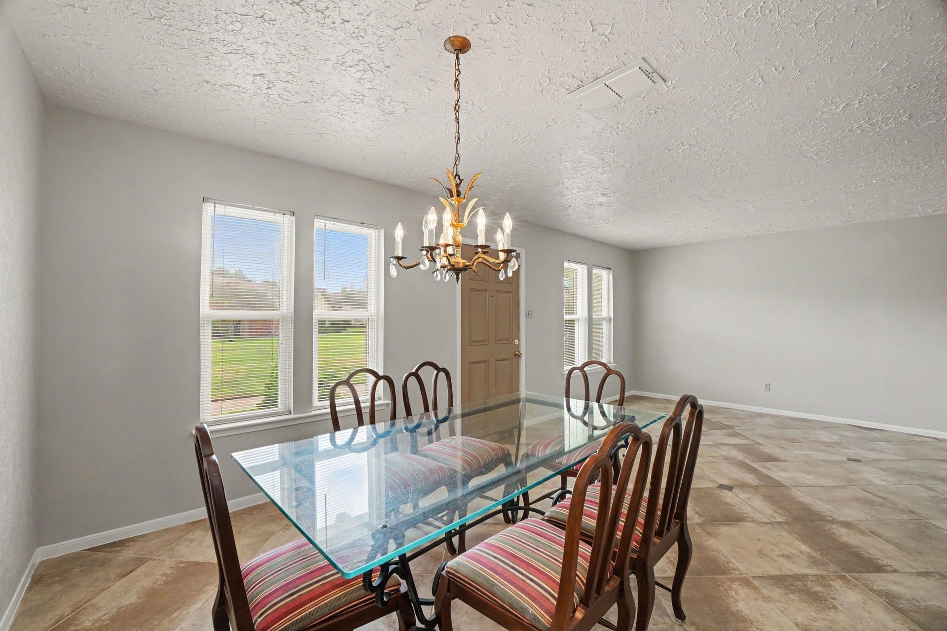 44 Chapparal Court, Missouri City, TX 77459 Large, light-filtering windows bring in plenty of natural daylight, while a wide doorway offers convenient access directly into the kitchen, ensuring effortless hosting and serving.