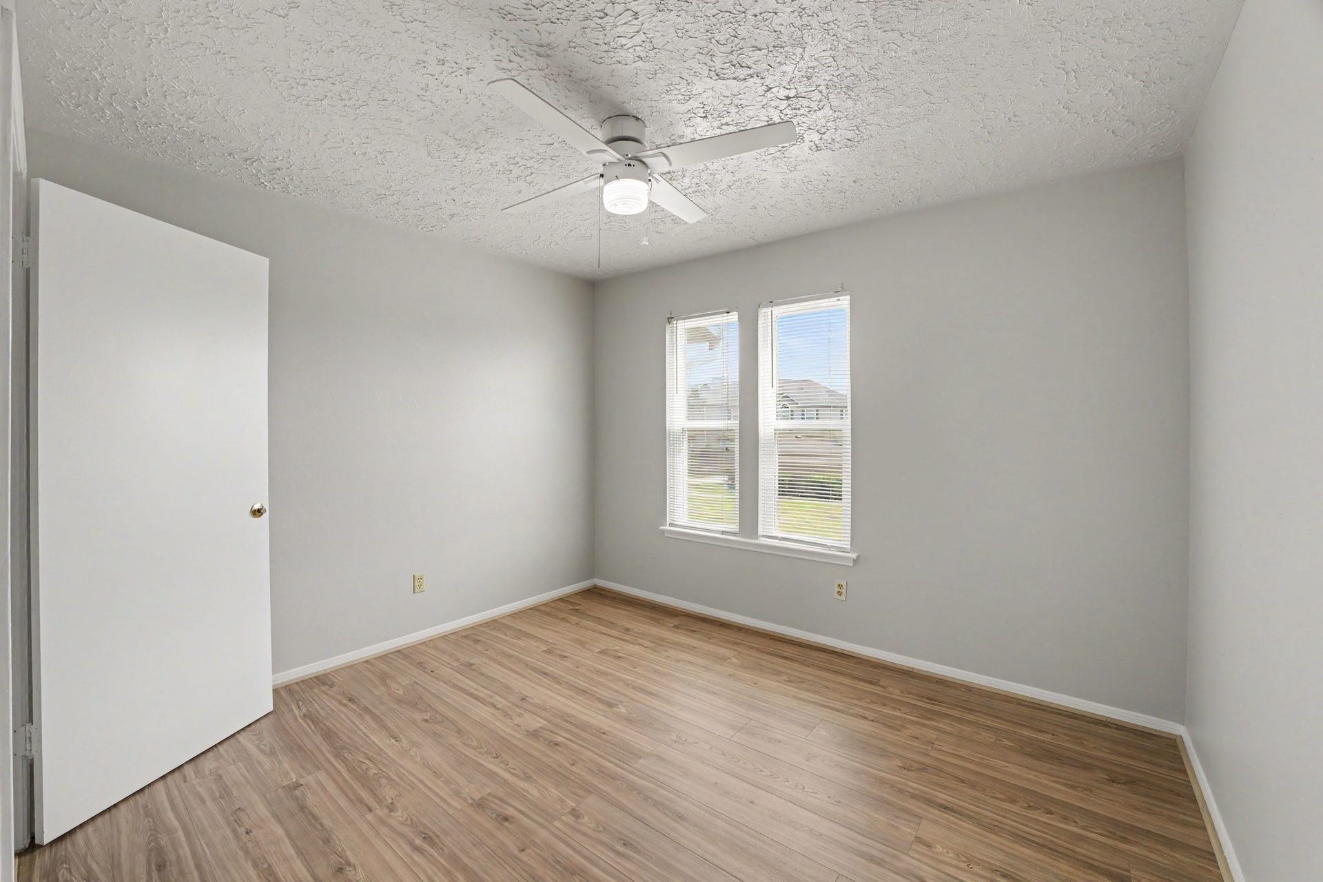 44 Chapparal Court, Missouri City, TX 77459 This flexible bedroom space features warm, wood-look plank flooring paired with soft neutral walls and crisp white baseboards for a clean, cohesive design.