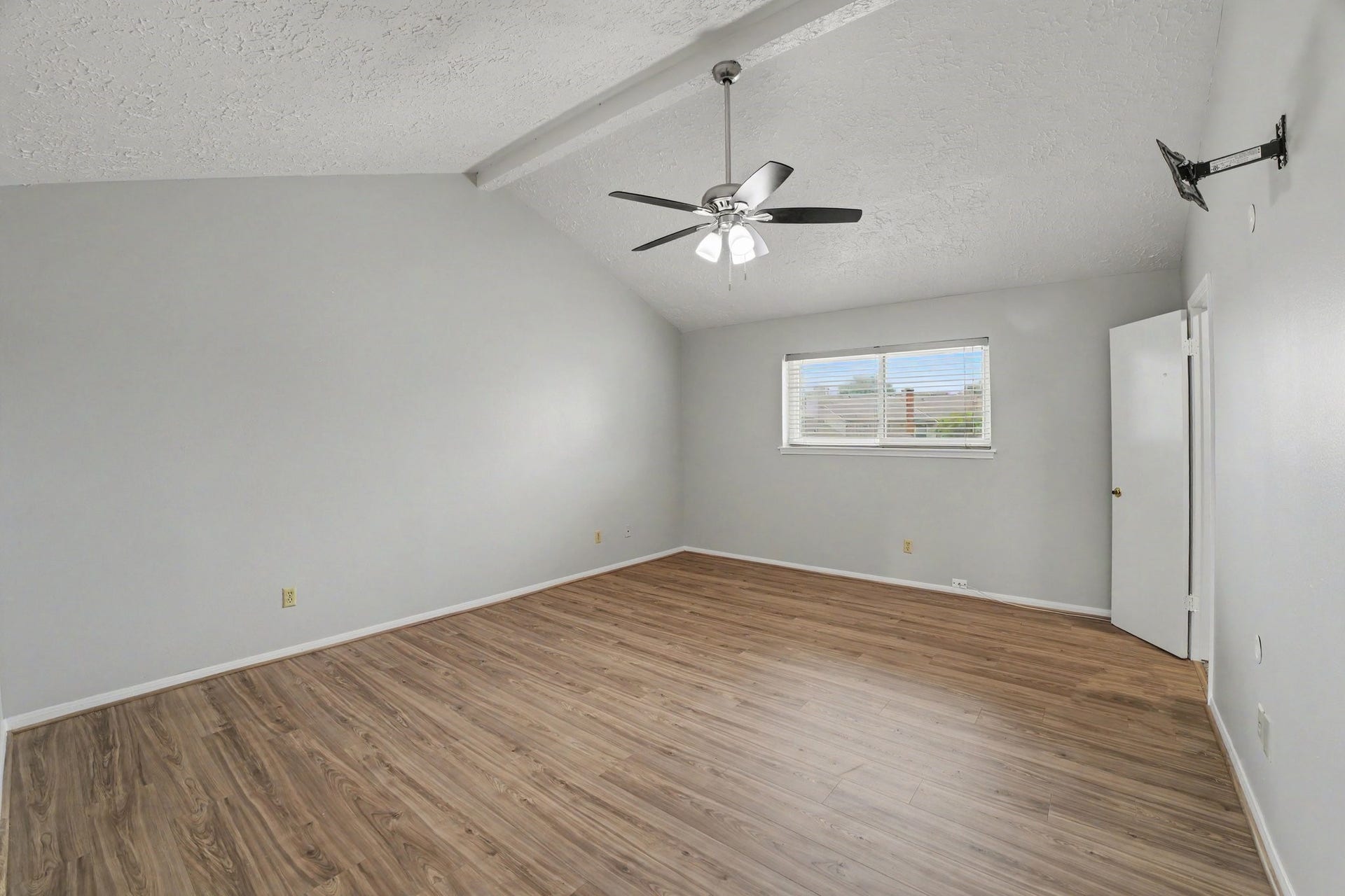 44 Chapparal Court, Missouri City, TX 77459 arm wood-look flooring stretches across the vast room, perfectly paired with soft neutral walls and clean white trim for a bright, serene atmosphere. The generous layout includes a large walk-in closet complete with built-in wire shelving and plush carpeting, offering plenty of storage space.