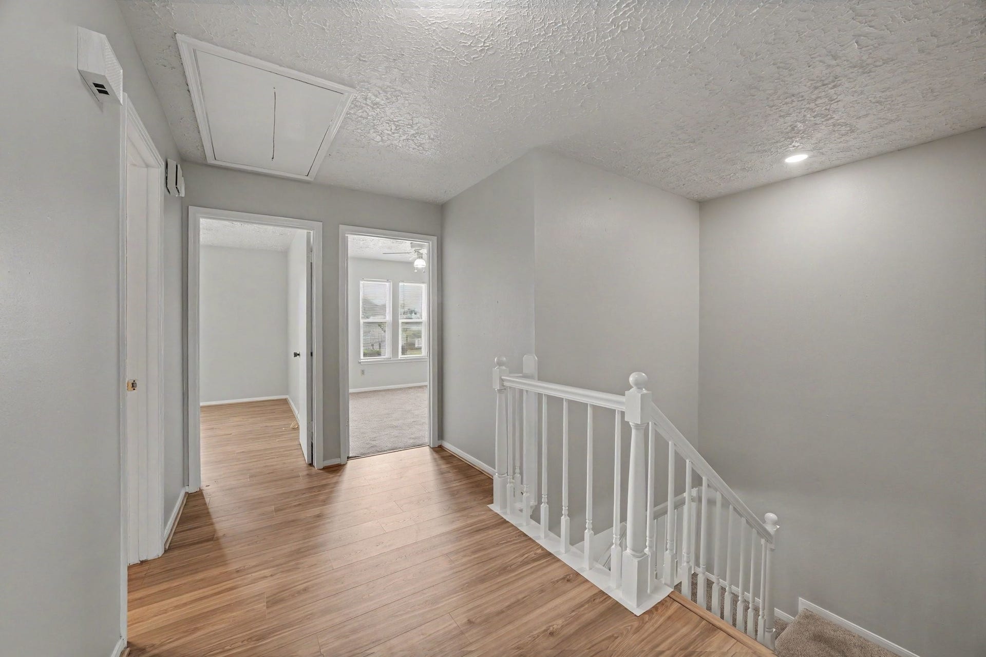 44 Chapparal Court, Missouri City, TX 77459 A white balustrade creates a clean boundary around the stairwell, while multiple doorways branch off toward the bedrooms.
