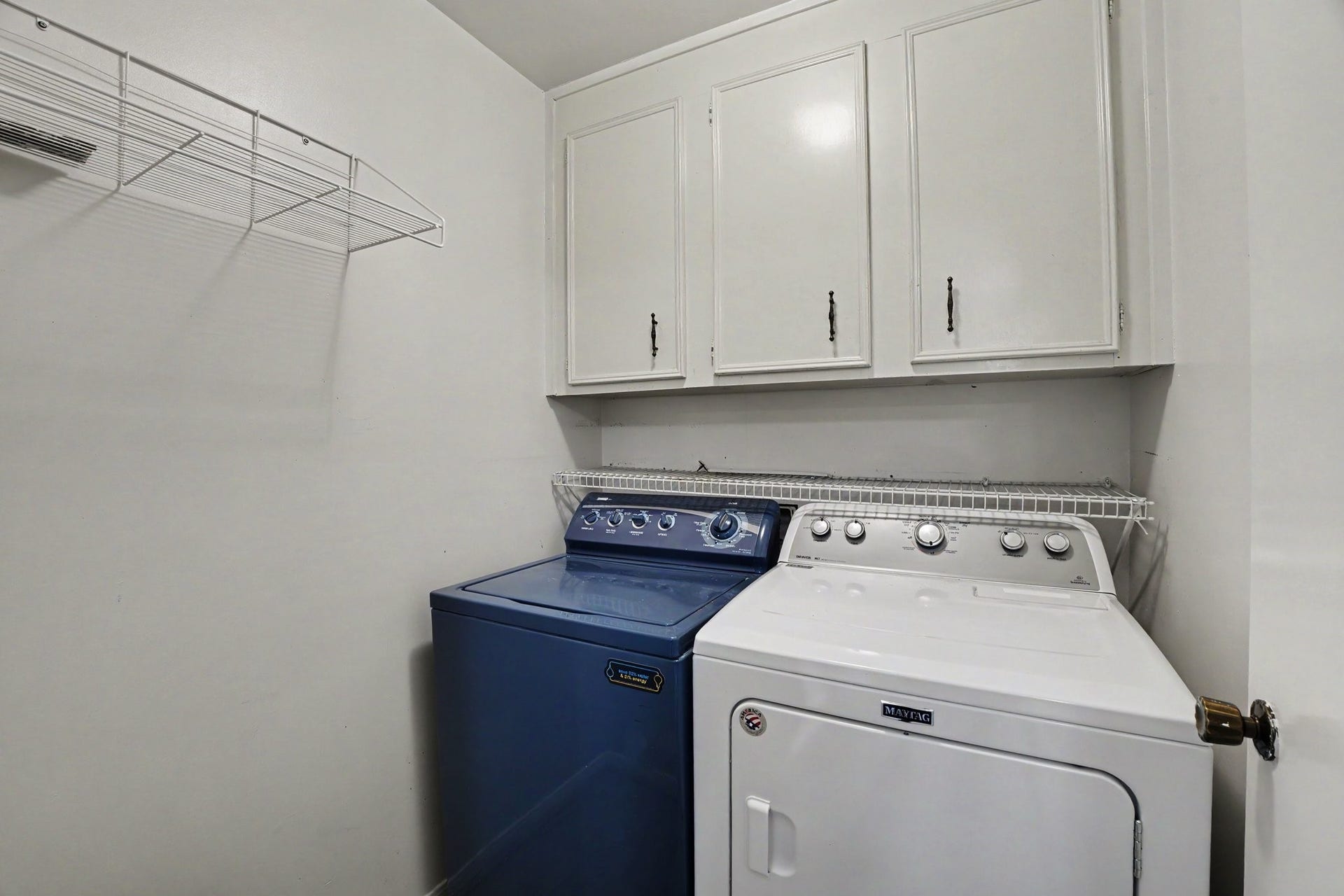 44 Chapparal Court, Missouri City, TX 77459 This dedicated indoor laundry room maximizes utility and convenience with smart storage solutions. Built-in white upper cabinets offer generous space to neatly store detergents, cleaning supplies, and linens out of sight.