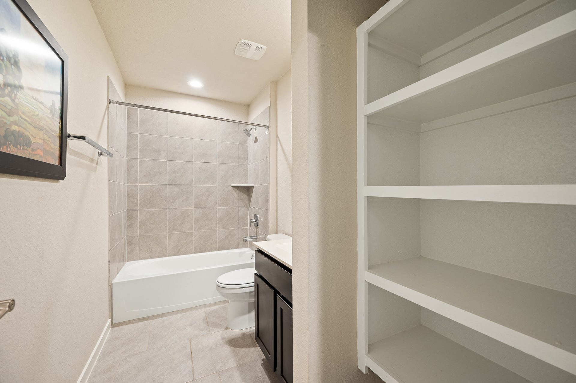 Hall bathroom with abundant storage space.