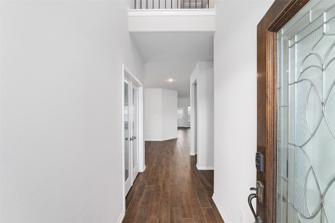 20755 Beeston Glade Lane, Katy, TX 77449 Beautiful entryway with high ceilings & wood looking tile flooring throughout the first floor