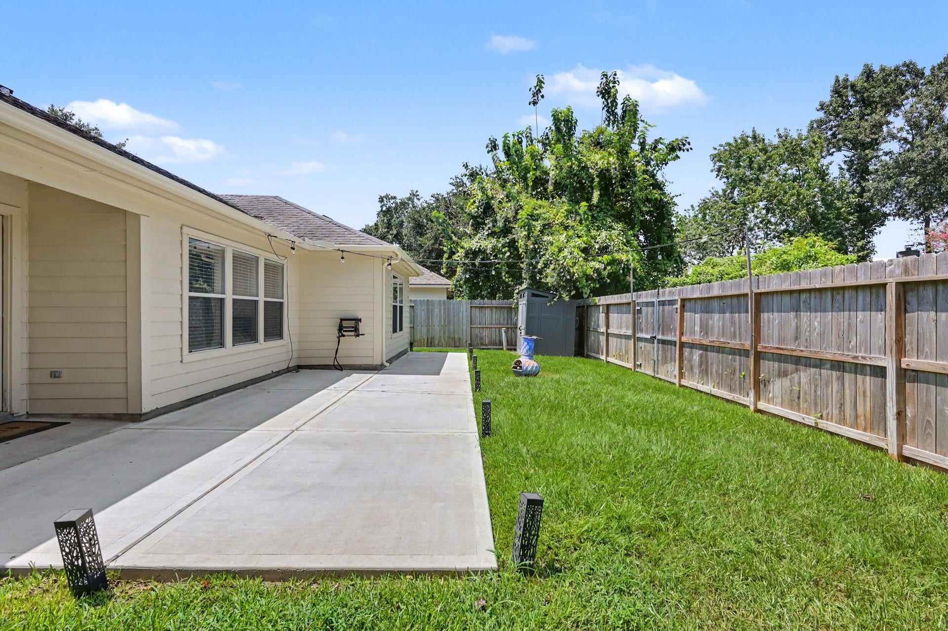 The fenced backyard offers room to play, garden, entertain, or simply enjoy a little breathing space with no immediate rear neighbor looking back at you.