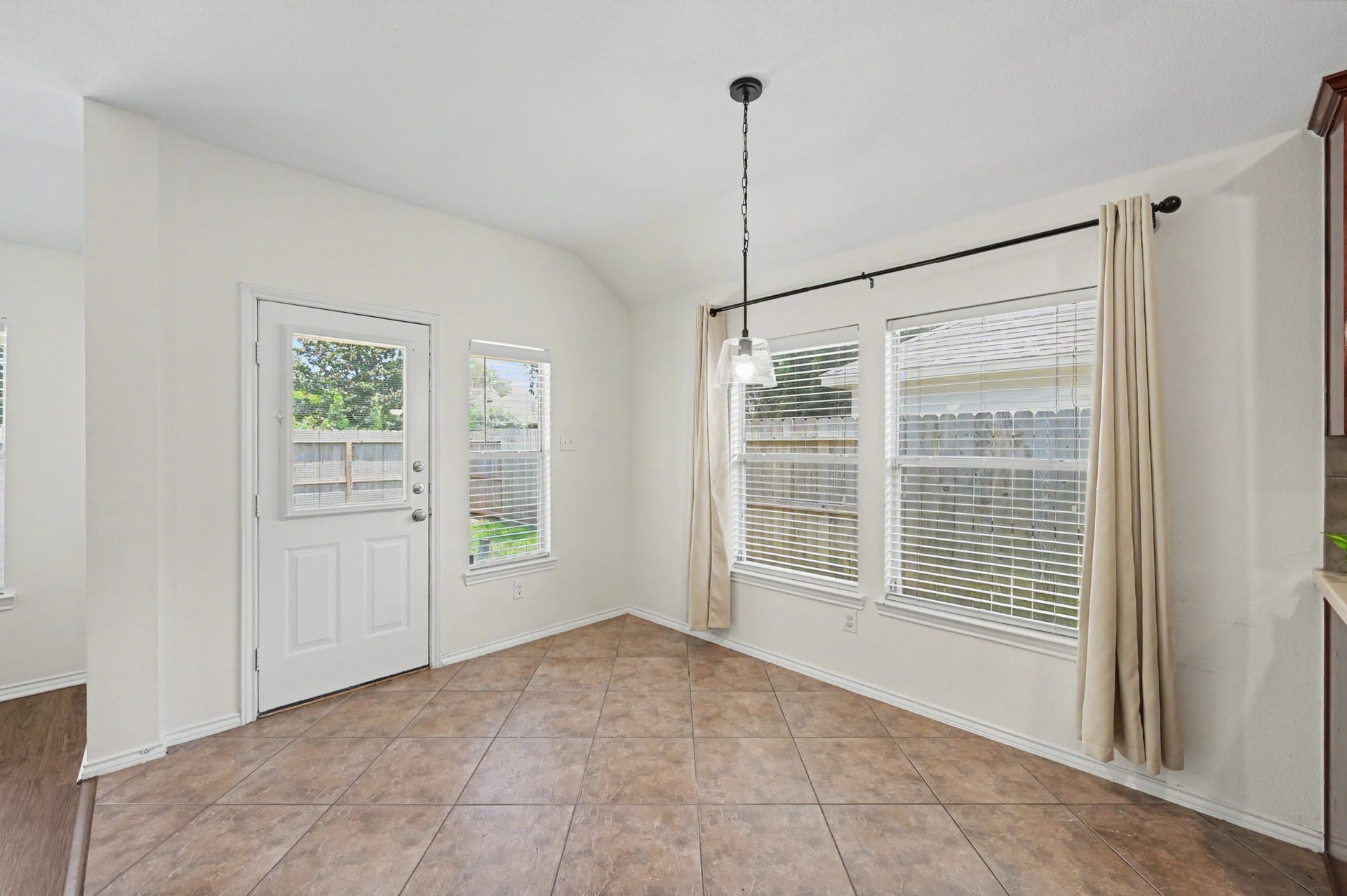 The breakfast nook sits beside the backyard door, making it the perfect landing place for morning coffee and casual meals as you take in your serene backyard.