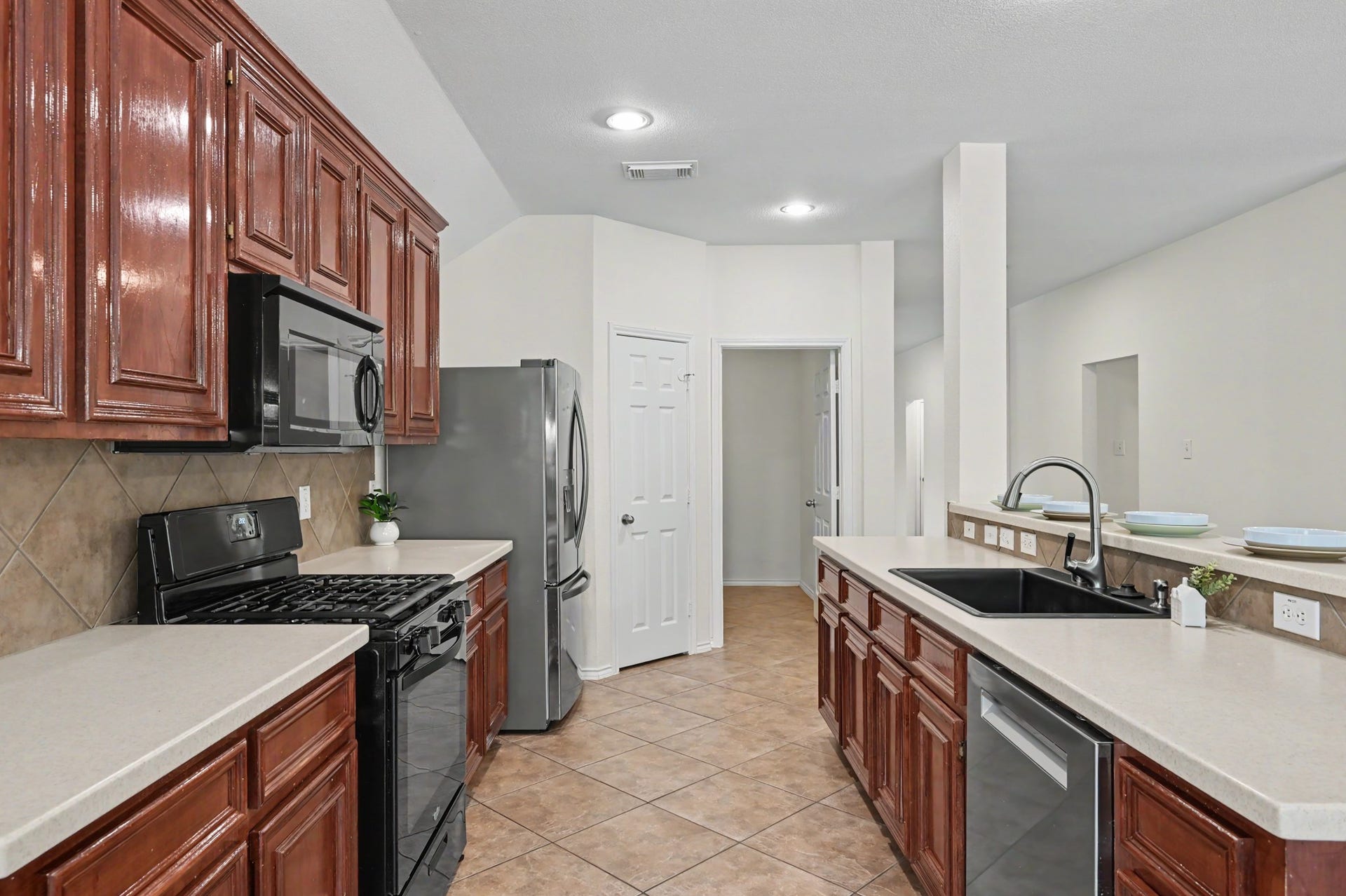 Just off your kitchen you have your pantry on the left and your large laundry room in the door on the right.