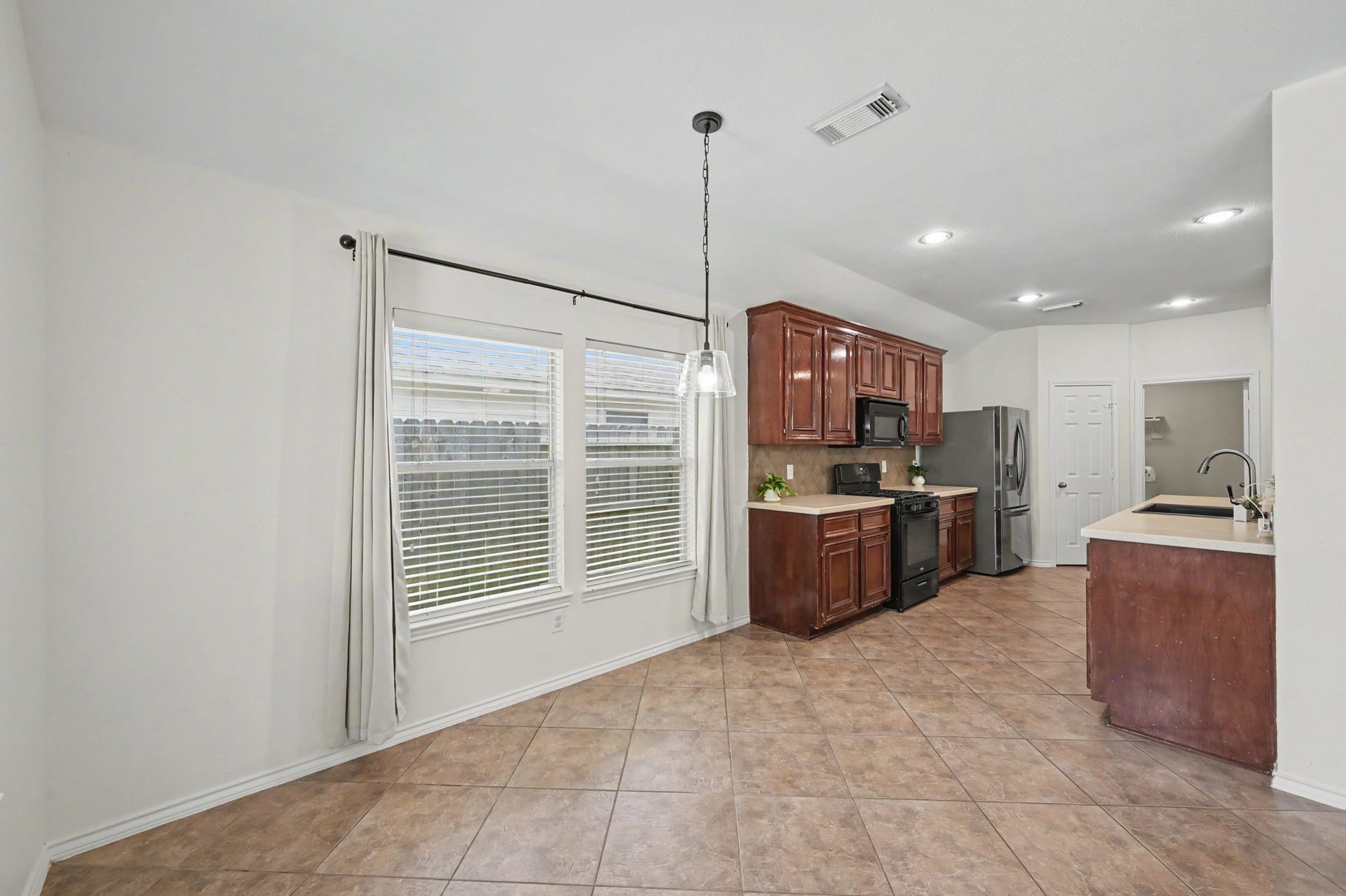 The kitchen and breakfast area flow naturally together, giving you room to cook, dine, and host without anyone disappearing into another room.