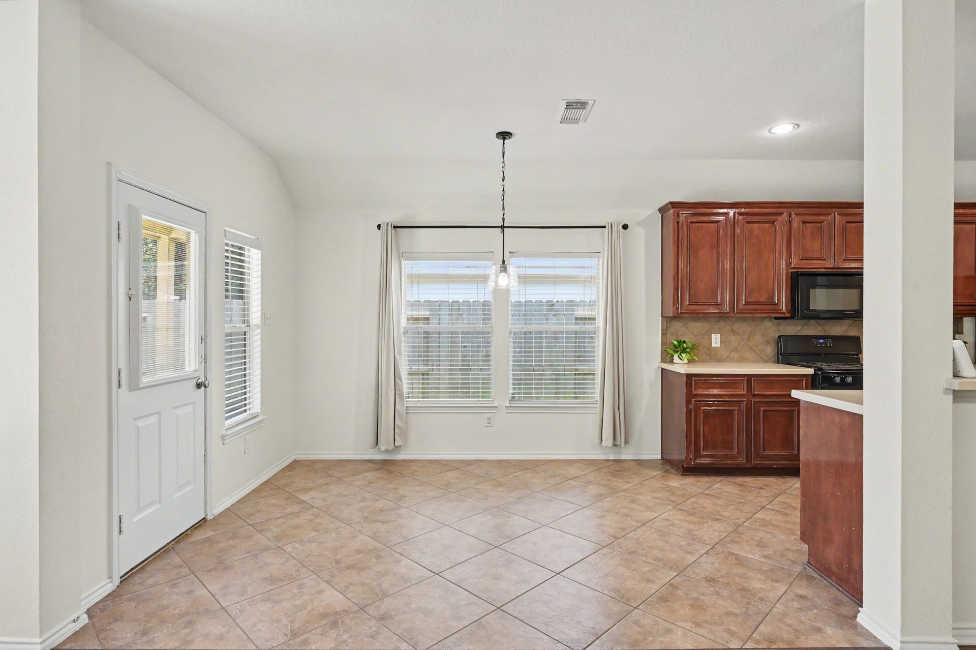 If you aren't much of a formal dining space person, this easily fits a large table and is conveniently located next to your kitchen.
