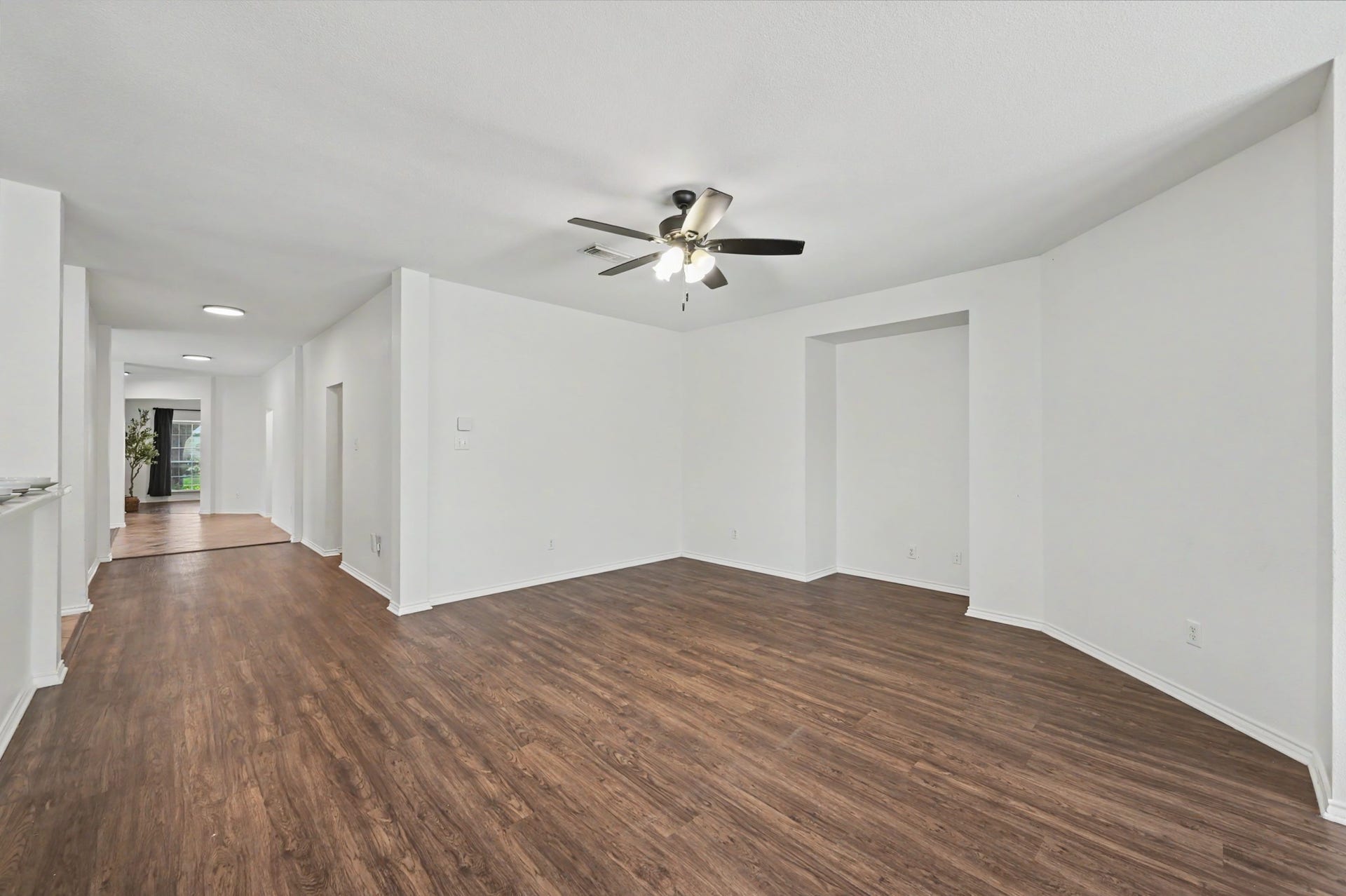Your living room is huge with plenty of space to arrange your furniture. Notice the neutral paint throughout the home creating a blank canvas for you.