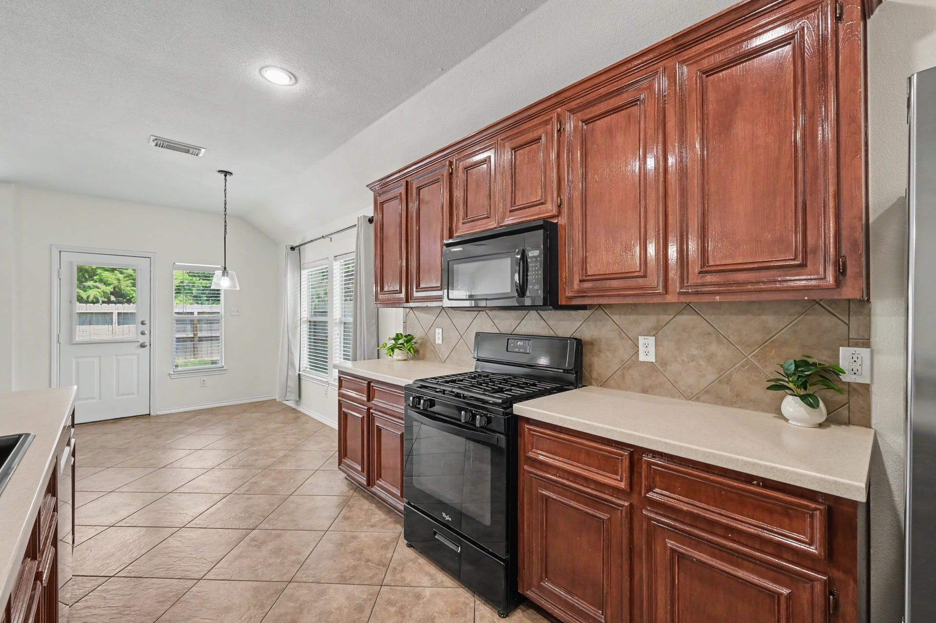 Check out the proximity to your back door. The kitchen extends toward the backyard, making it easy to carry meals outside and keeping outdoor entertaining connected to the heart of the home.