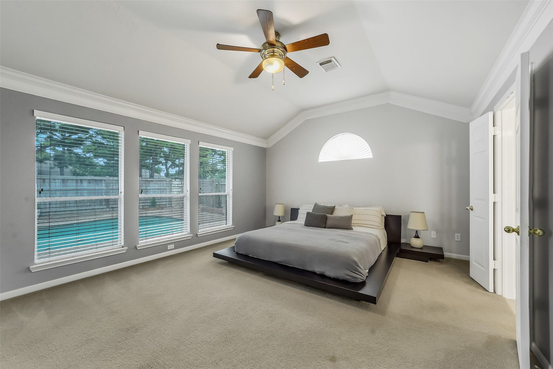 11219 Timbercreek Falls Drive, Houston, TX 77095 Experience luxury in this spacious primary bedroom, offering stunning views of the pool.