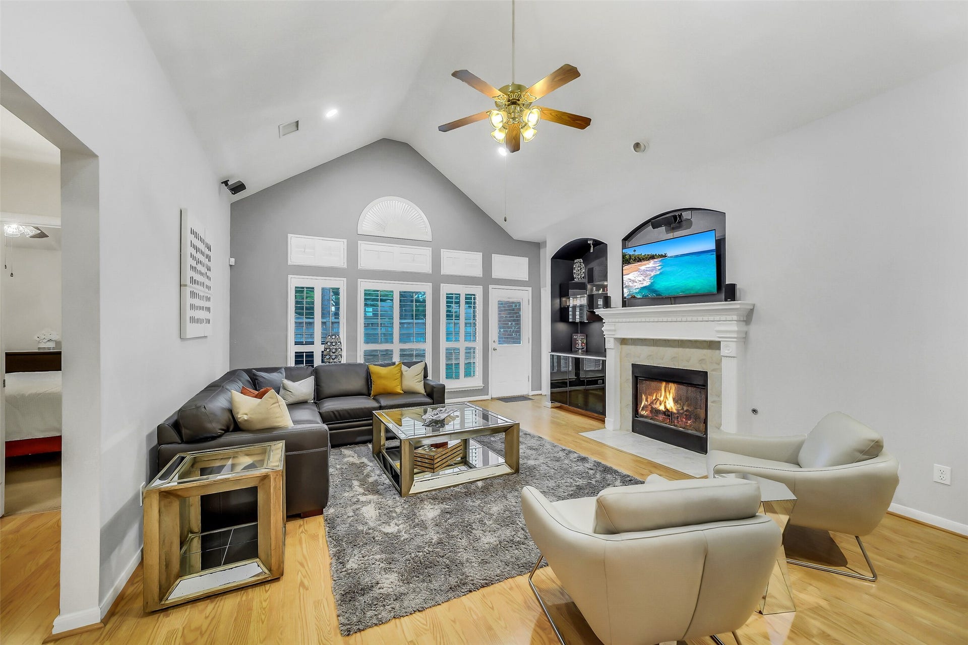 11219 Timbercreek Falls Drive, Houston, TX 77095 Living room with ceiling fan, recessed lighting, cozy fireplace, and elegant floors.