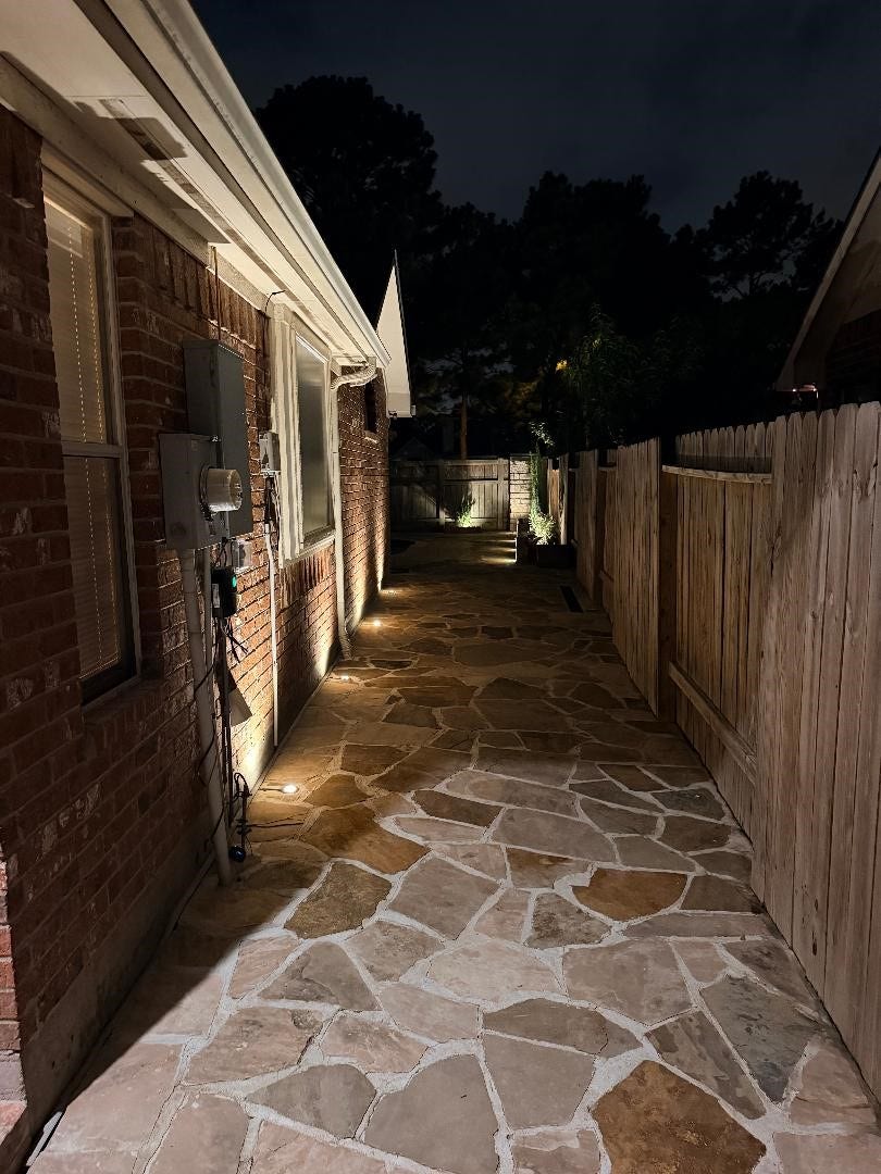 11219 Timbercreek Falls Drive, Houston, TX 77095 Landscape lighting on side of the backyard.