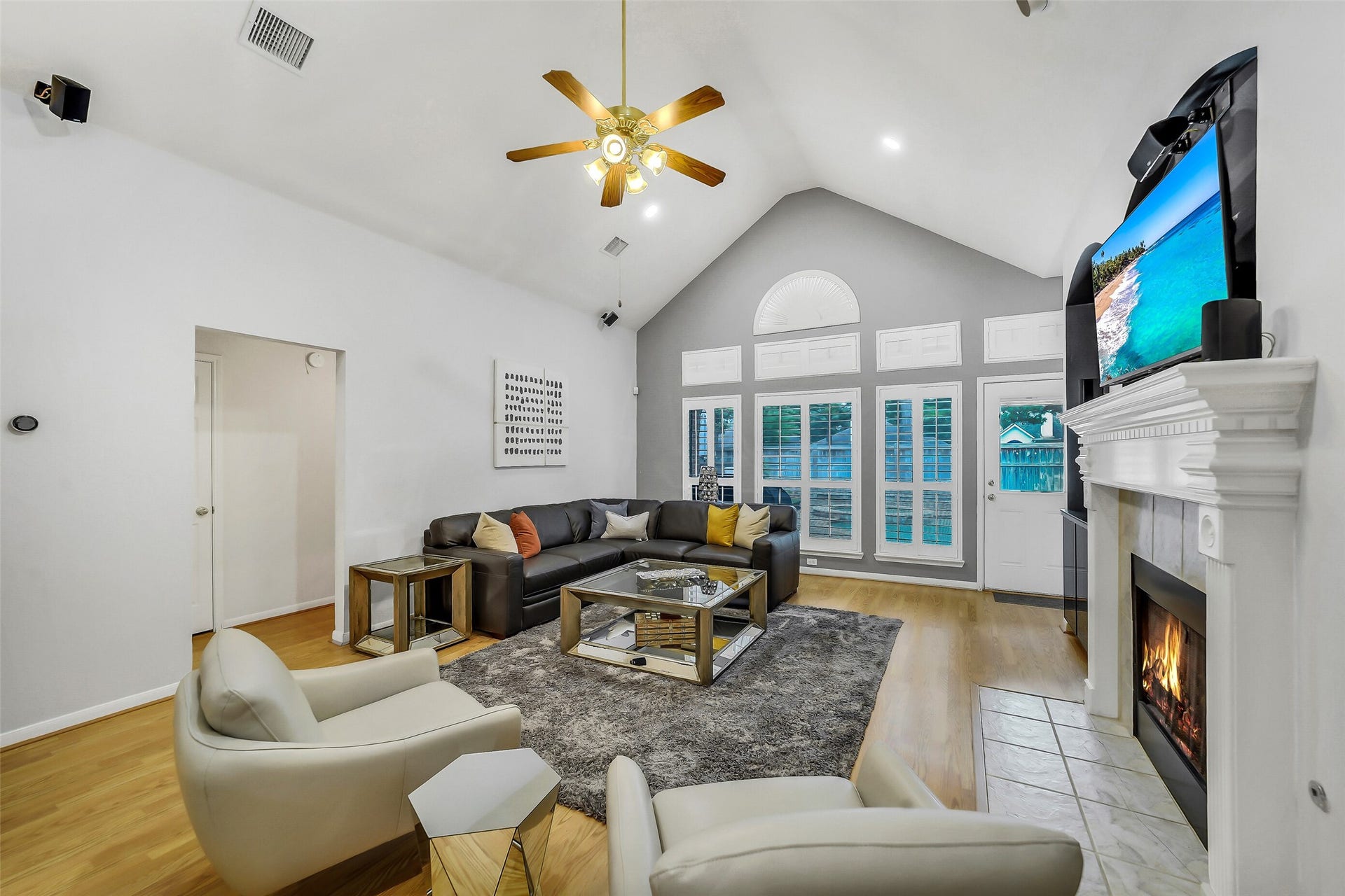 11219 Timbercreek Falls Drive, Houston, TX 77095 Discover the charm of this expansive family room, where a vaulted ceiling meets a cozy fireplace, creating the perfect blend of space and warmth.