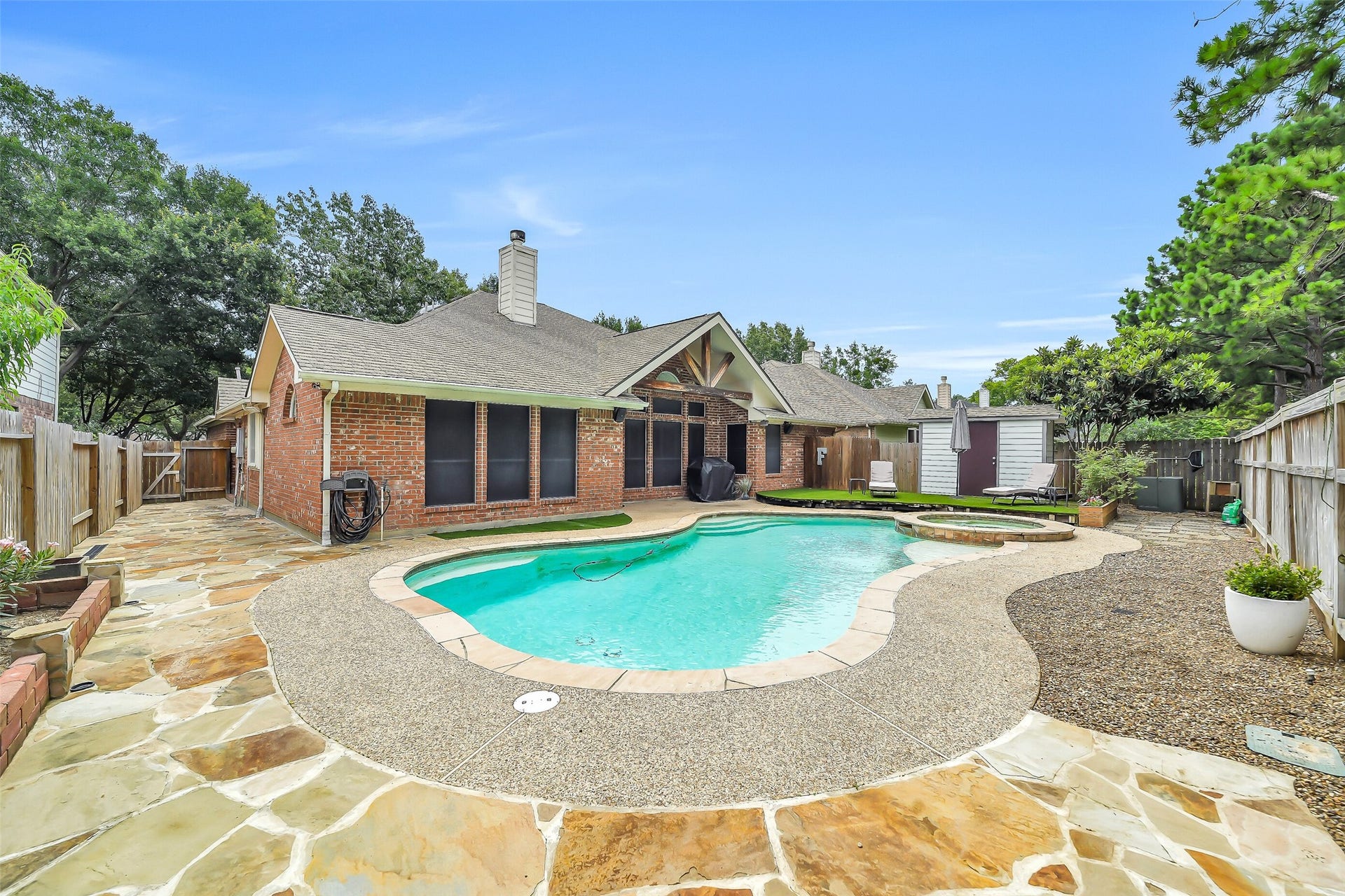 11219 Timbercreek Falls Drive, Houston, TX 77095 This low-maintenance backyard oasis features a sparkling pool and spa, a spacious deck perfect for entertaining, a covered patio, a handy storage shed, and stunning flagstone accents.