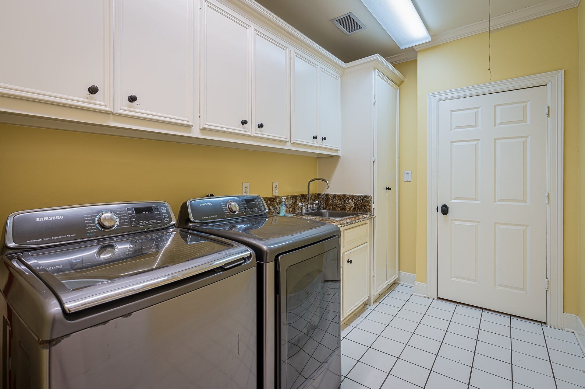 Spacious utility room with sink and plenty of storage space