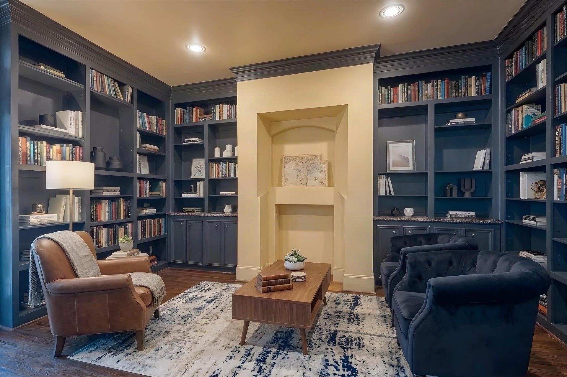 This space is imagined as an in-home library with built-in shelving, cozy seating, and a warm, inviting atmosphere perfect for reading and relaxation. *Photo is virtually staged*