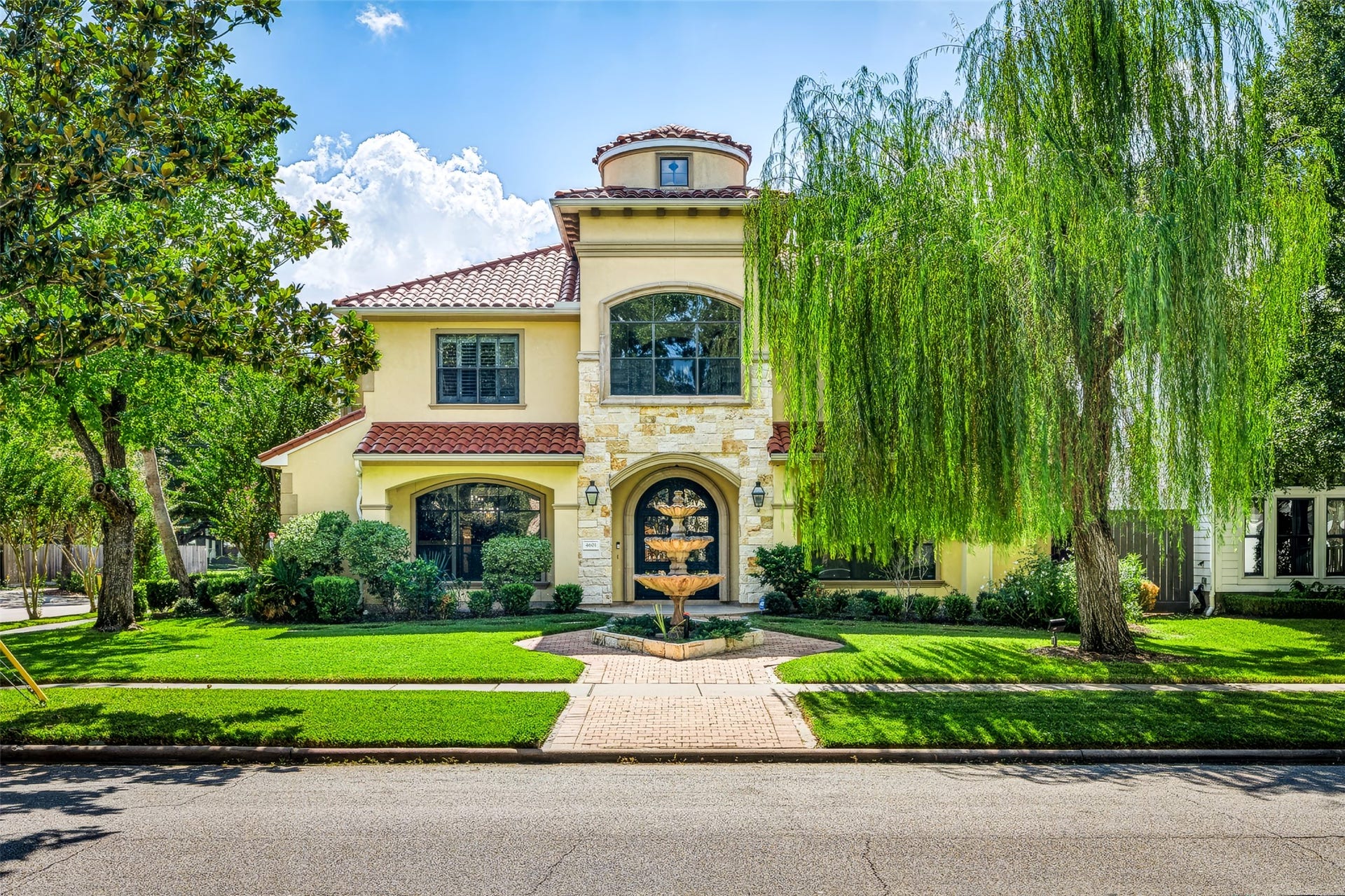 Elegant Mediterranean-style home in the heart of Bellaire. Positioned on a corner lot with, with lush landscaping and water feature that give the home great curb appeal.