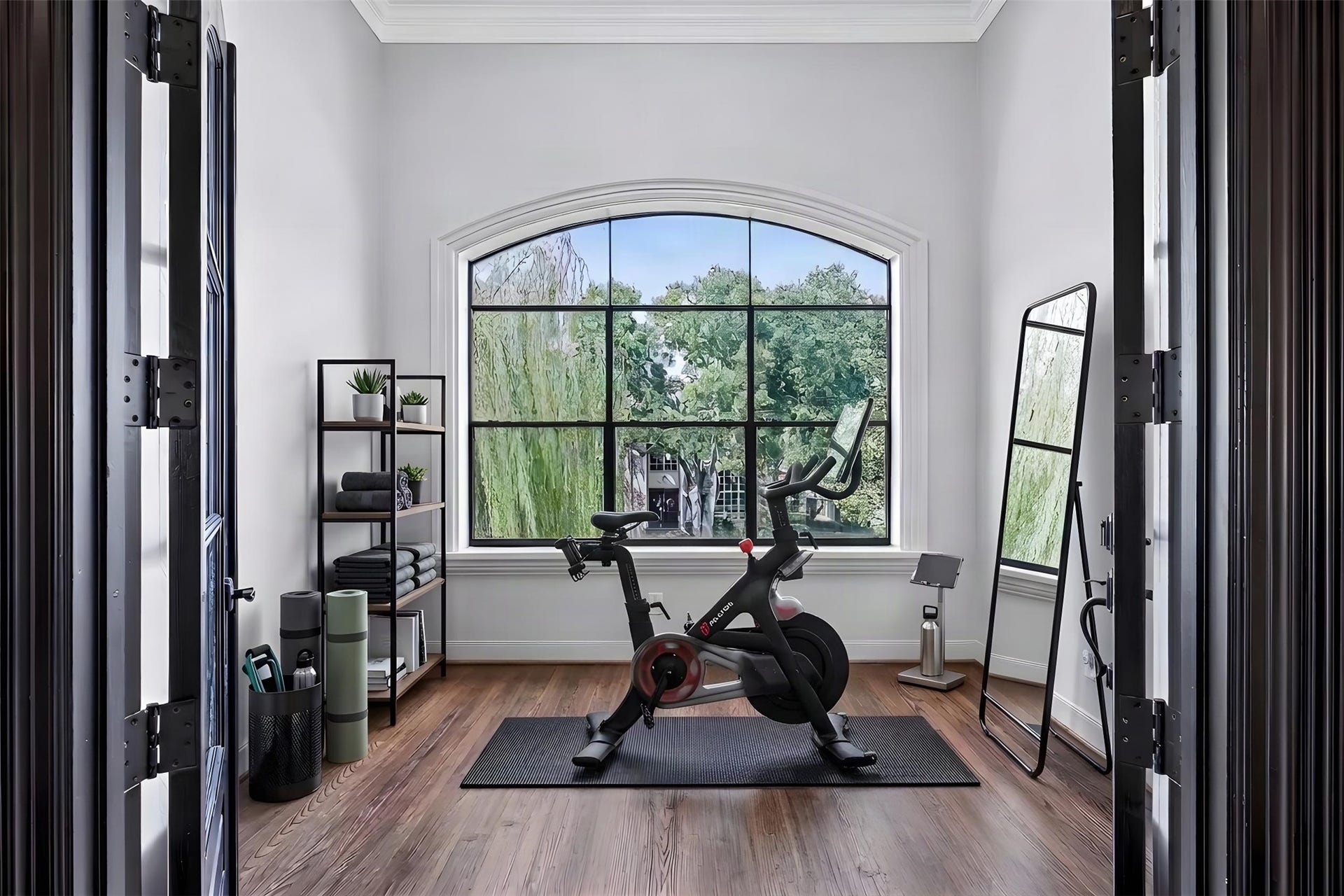 Inside the sunroom, it is bright and inviting. The space is imagined as a home gym or yoga room.