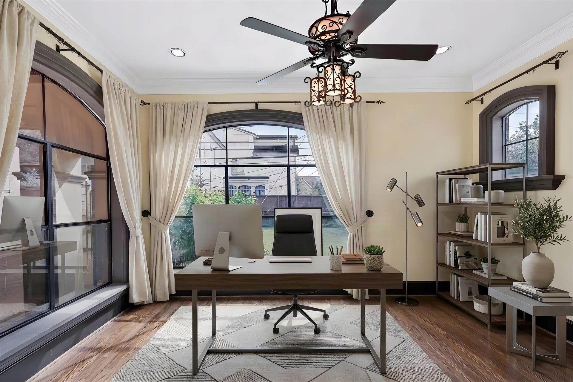 First-floor room imagined as a home office. Large arched windows bring in plenty of natural light. *Photo is virtually staged*