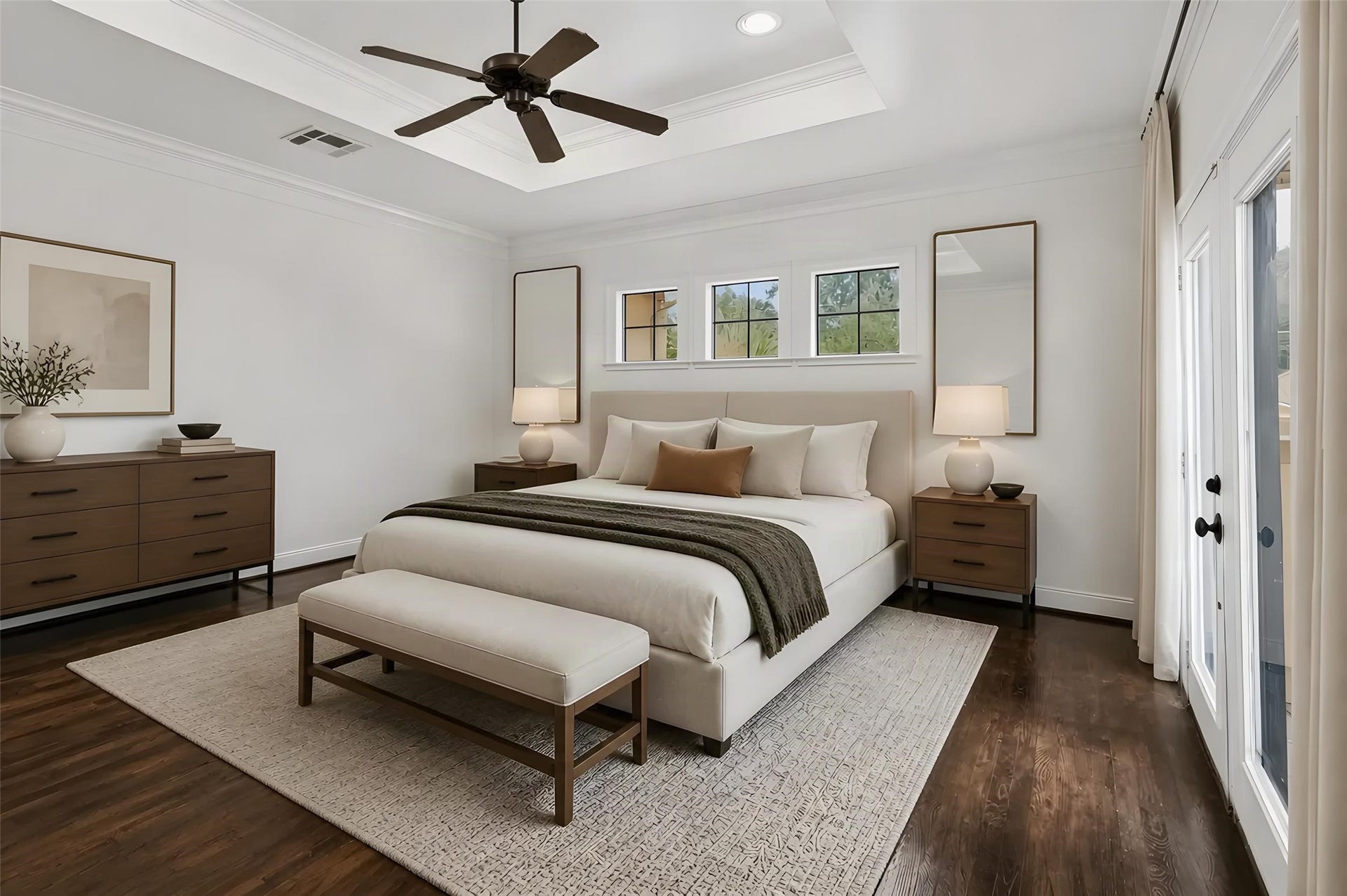 Spacious and elegant primary bedroom featuring rich hardwood floors, large windows for natural light. *Photo is virtually staged*