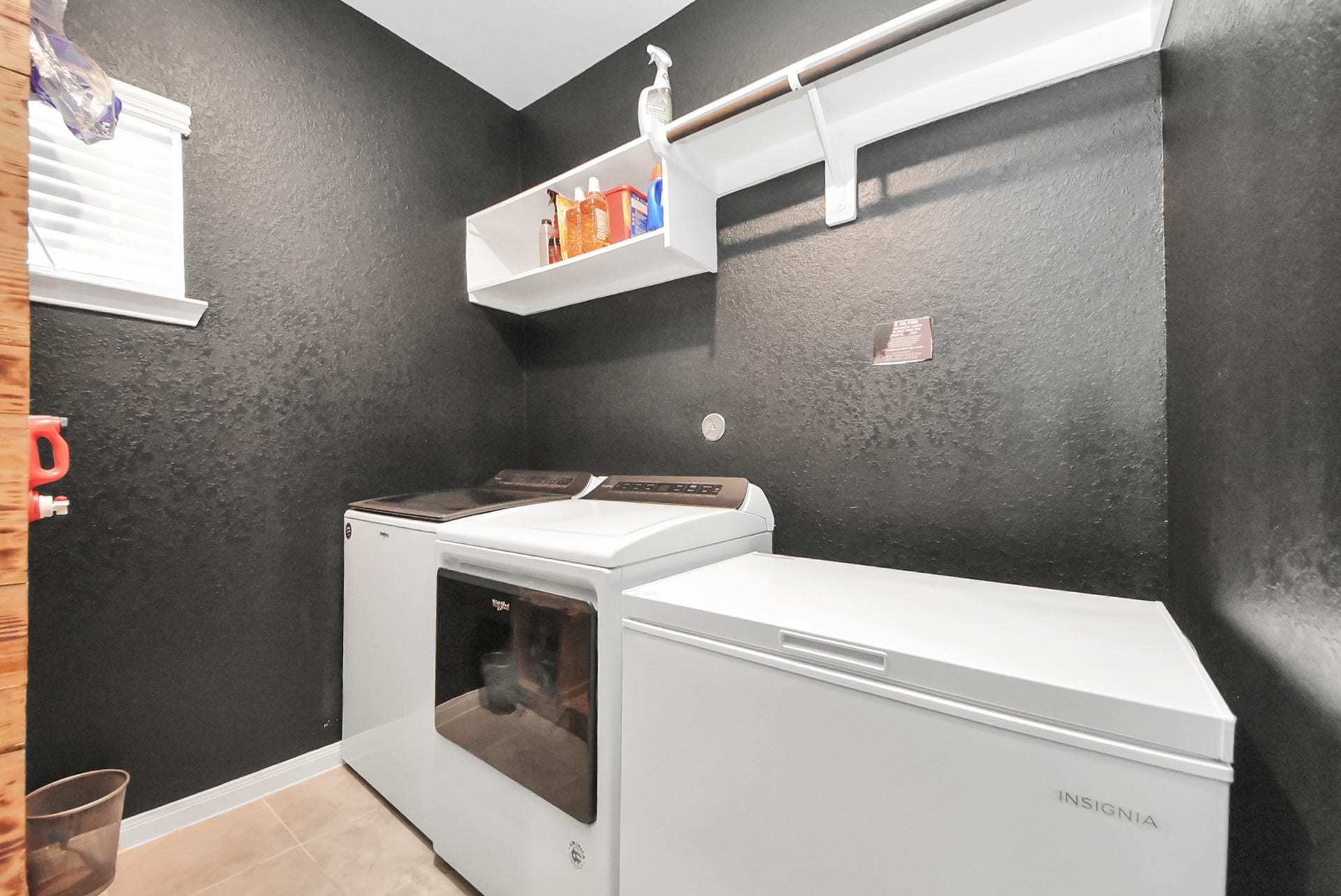 930 Pismo Lane, Rosharon, TX 77583 Crisp laundry room with shelving and storage rack for drying clothes.