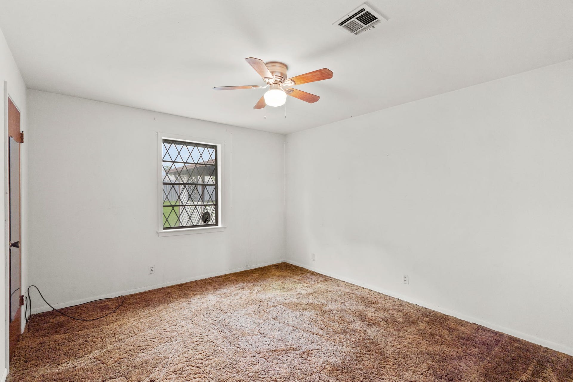 8218 Avenue M, Santa Fe, TX 77510 Bedroom with natural light and ceiling fan.