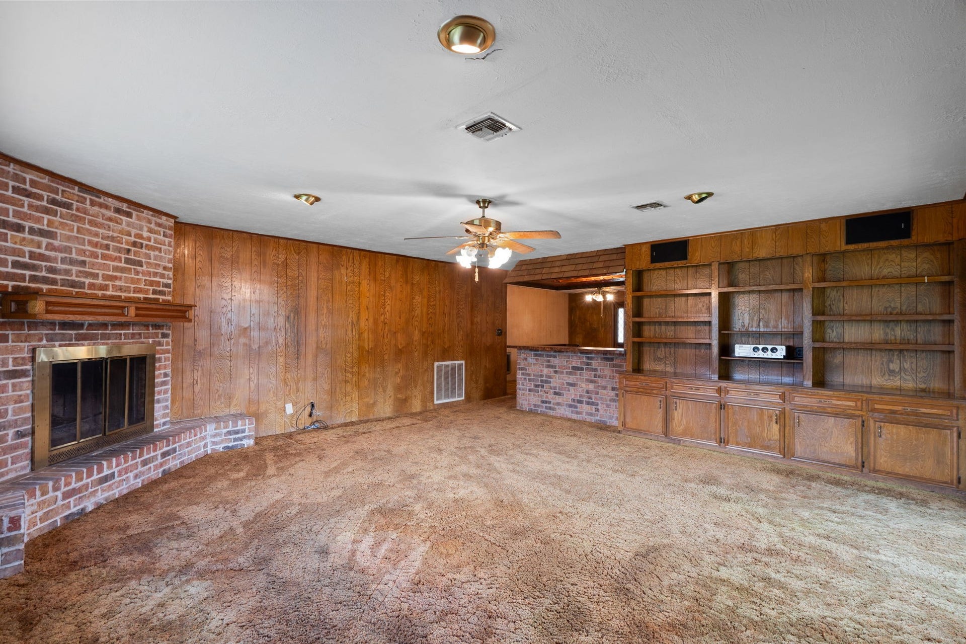 8218 Avenue M, Santa Fe, TX 77510 Built-in shelving, cabinetry, and brick fireplace.