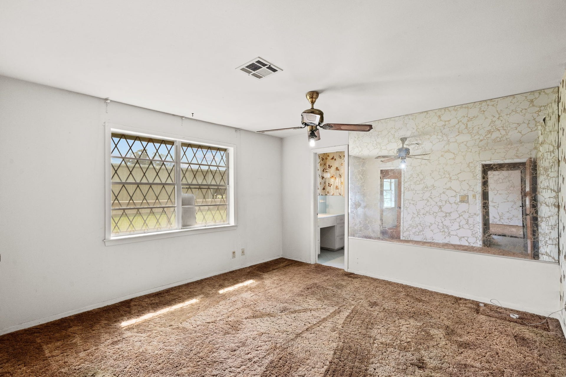 8218 Avenue M, Santa Fe, TX 77510 Primary bedroom with large window and adjoining bathroom.