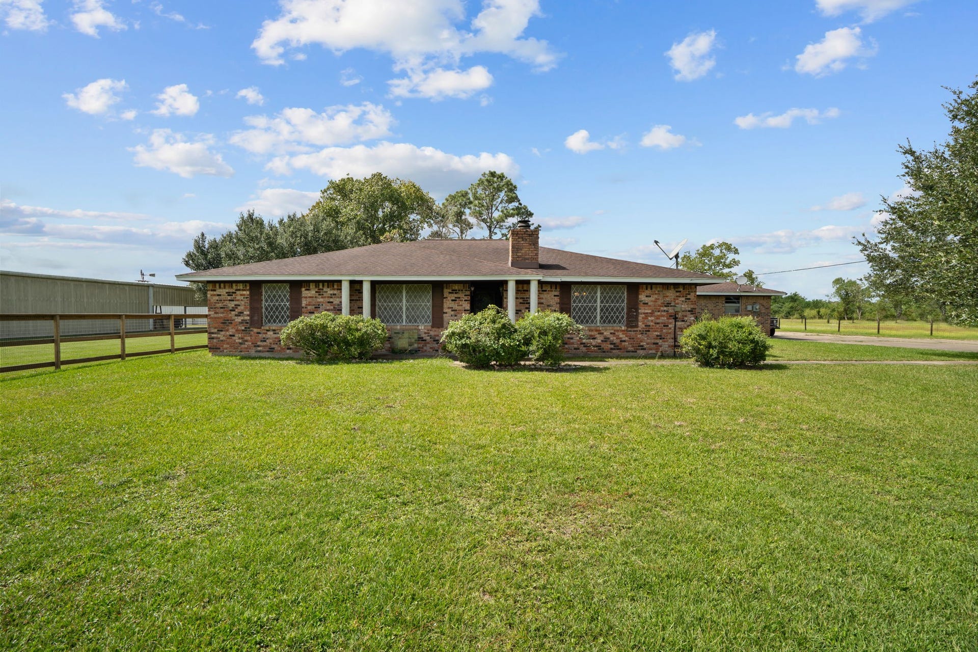8218 Avenue M, Santa Fe, TX 77510 Brick home situated on 5 acres with mature trees and open green space.