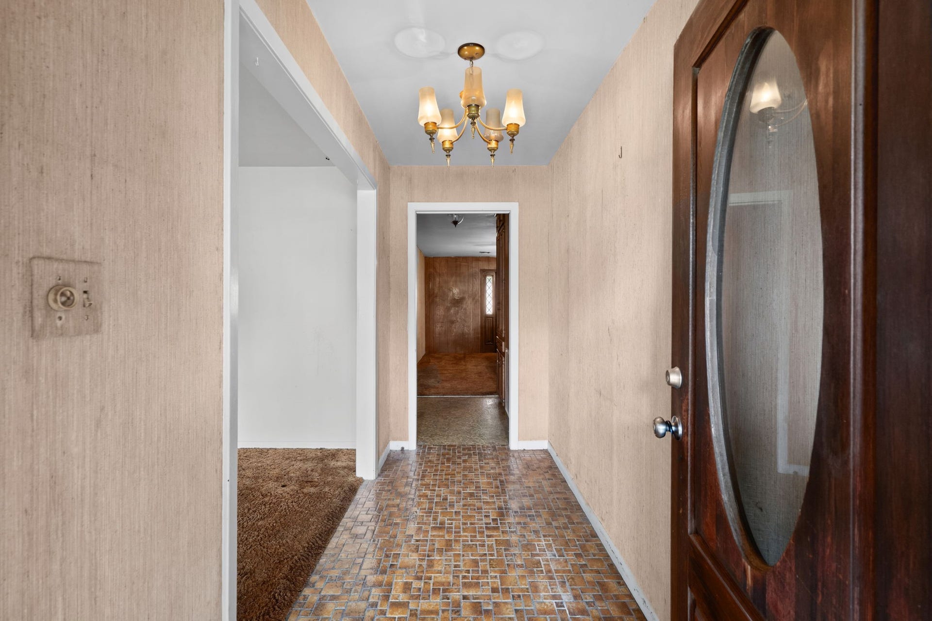 8218 Avenue M, Santa Fe, TX 77510 Entryway with brick-pattern flooring and chandelier lighting.