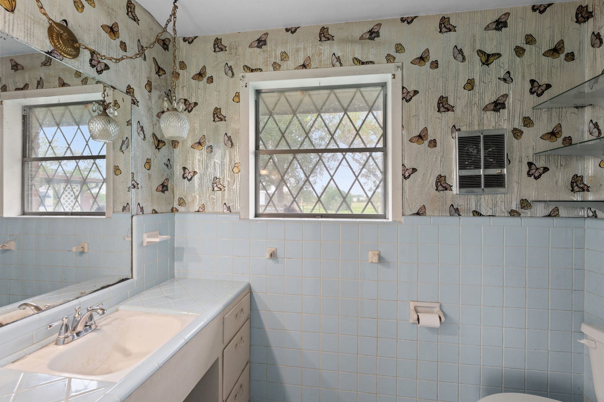 8218 Avenue M, Santa Fe, TX 77510 Bathroom with blue tile accents, vanity, and natural light.