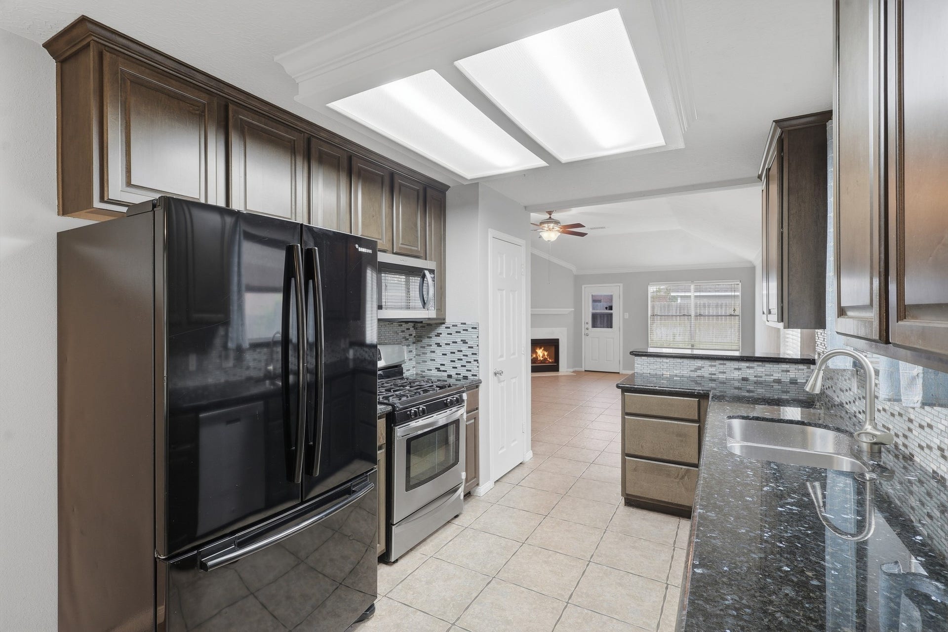 1242 Hunter Wood Drive, League City, TX 77573 Functional kitchen design with granite counters and convenient access to the dining and breakfast areas.